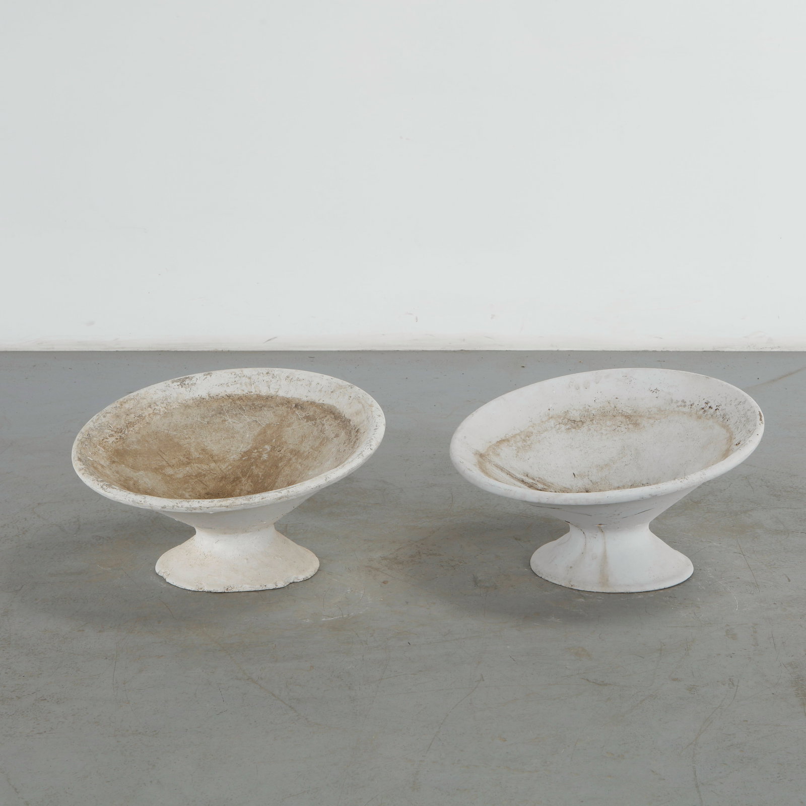 Willy Guhl, Pair of Off Kilter Planters, 1960s: A pair of rare asymmetrical planters by Willy Guhl, featuring a bold modernist design. TOP Diameter: 25 in. BASE Diameter: 13 in. Height: 14.5 in. Condition Wear commensurate with age an