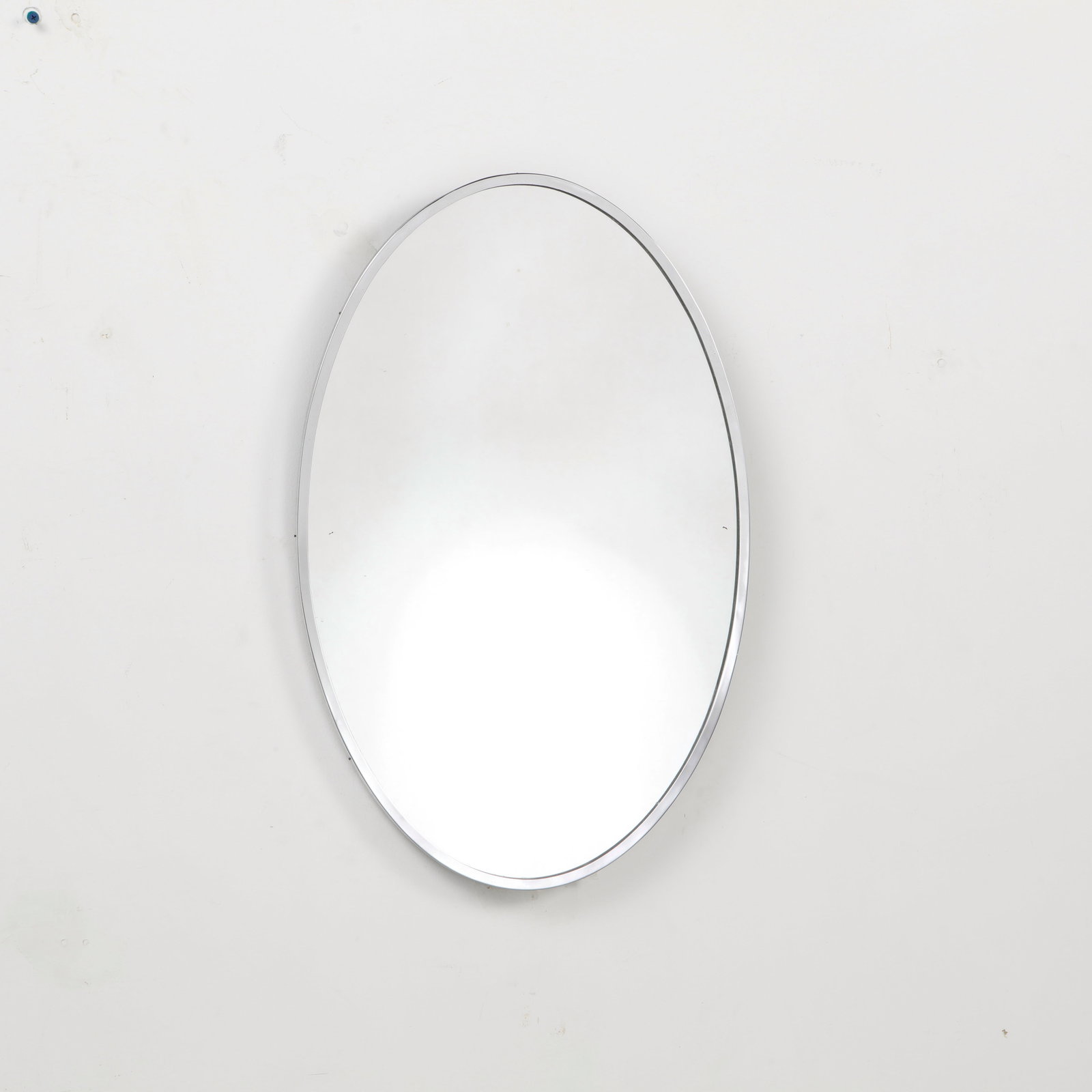 Mid-Century Wood Mirror, 1960s: This oval mirror is an authentic example of 1960s minimalist European design showcasing the era's transition toward clean, industrialized, and functional home decor. Height: 26 in. Width: 16.75 in