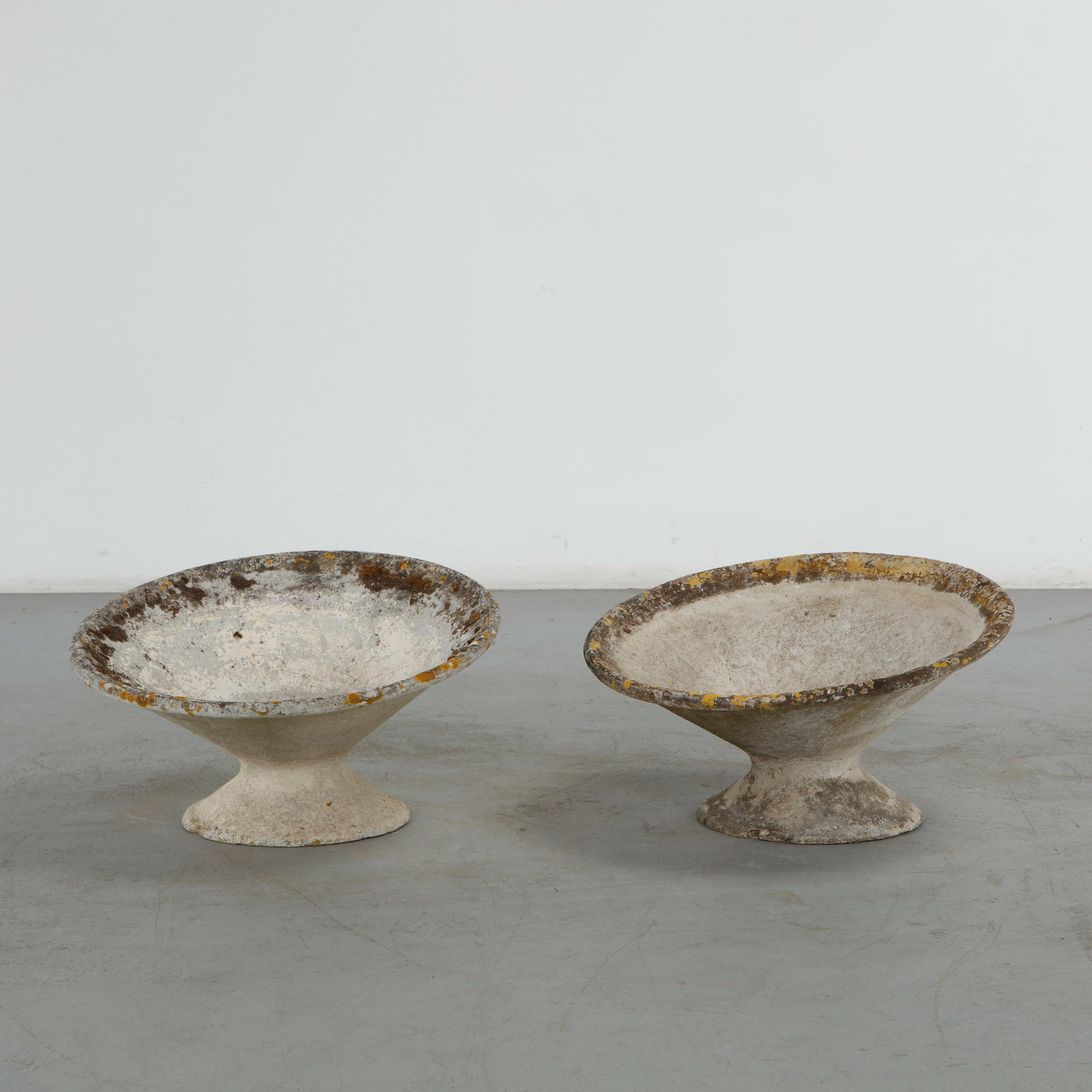 Willy Guhl, Pair of Off Kilter Planters, 1960s: A pair of rare asymmetrical planters by Willy Guhl, featuring a bold modernist design. TOP Diameter: 25 in. BASE Diameter: 13 in. Height: 14.5 in. Condition Wear commensurate with age an