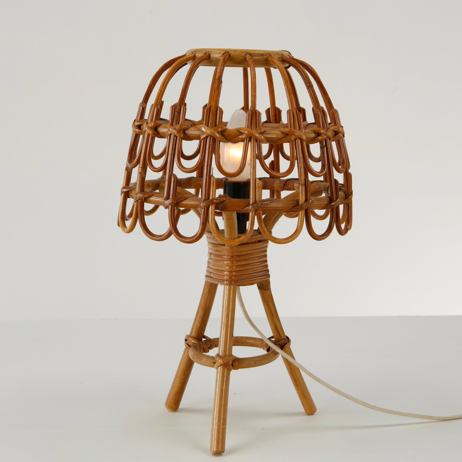 Louis Sognot, Rattan Cage Table Lamp, 1960s: Crafted in bamboo this tripod table lamp exemplifies Louis Sognot celebrated exploration of natural materials. Its airy construction diffuses a warm ambient light while highlighting exceptional French