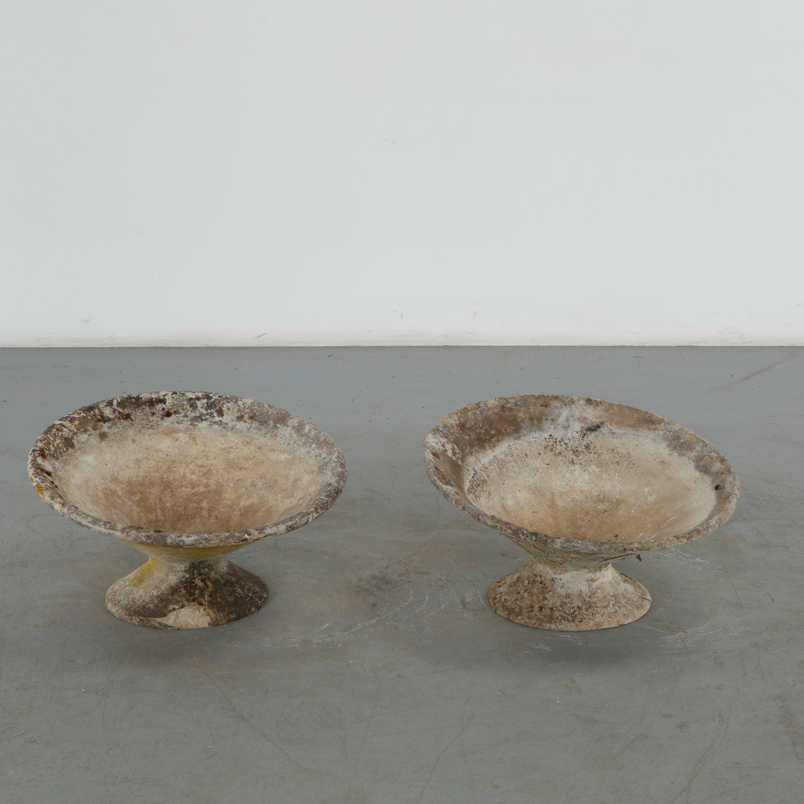 Willy Guhl, Pair of Off Kilter Planters, 1960s: A pair of rare asymmetrical planters by Willy Guhl, featuring a bold modernist design. TOP Diameter: 25 in. BASE Diameter: 13 in. Height: 14.5 in. Condition Wear commensurate with age an