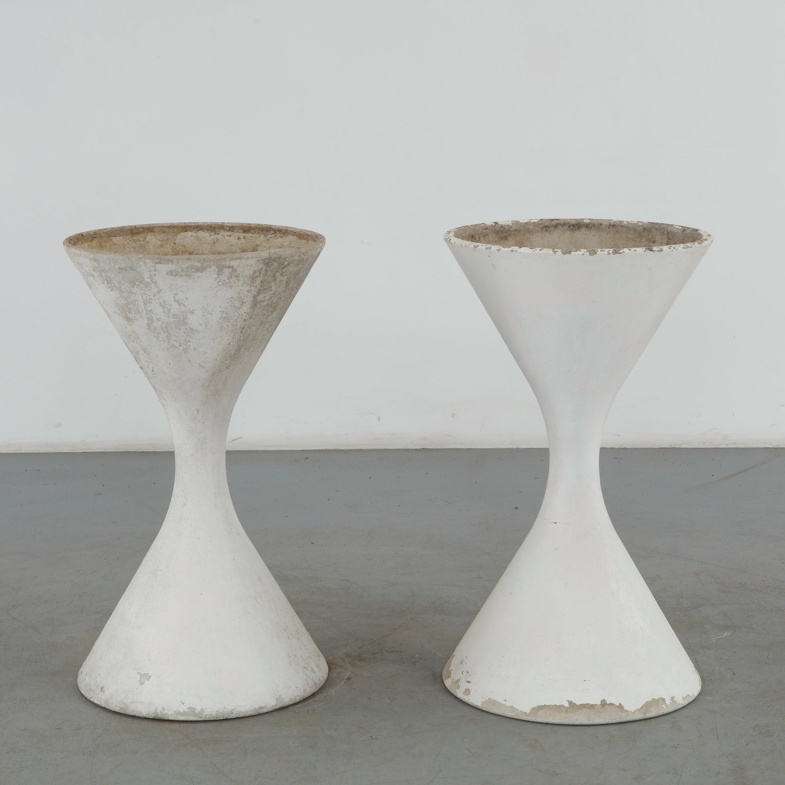 Willy Guhl, Pair of Large Diabolo Planters, 1960s: Pair of Willy Guhl large diabolo planters manufactured by Eternit, Switzerland. Height: 38 in. Diameter: 21.5 in. Condition Wear commensurate with age and evidence of outdoor use. Outdoo