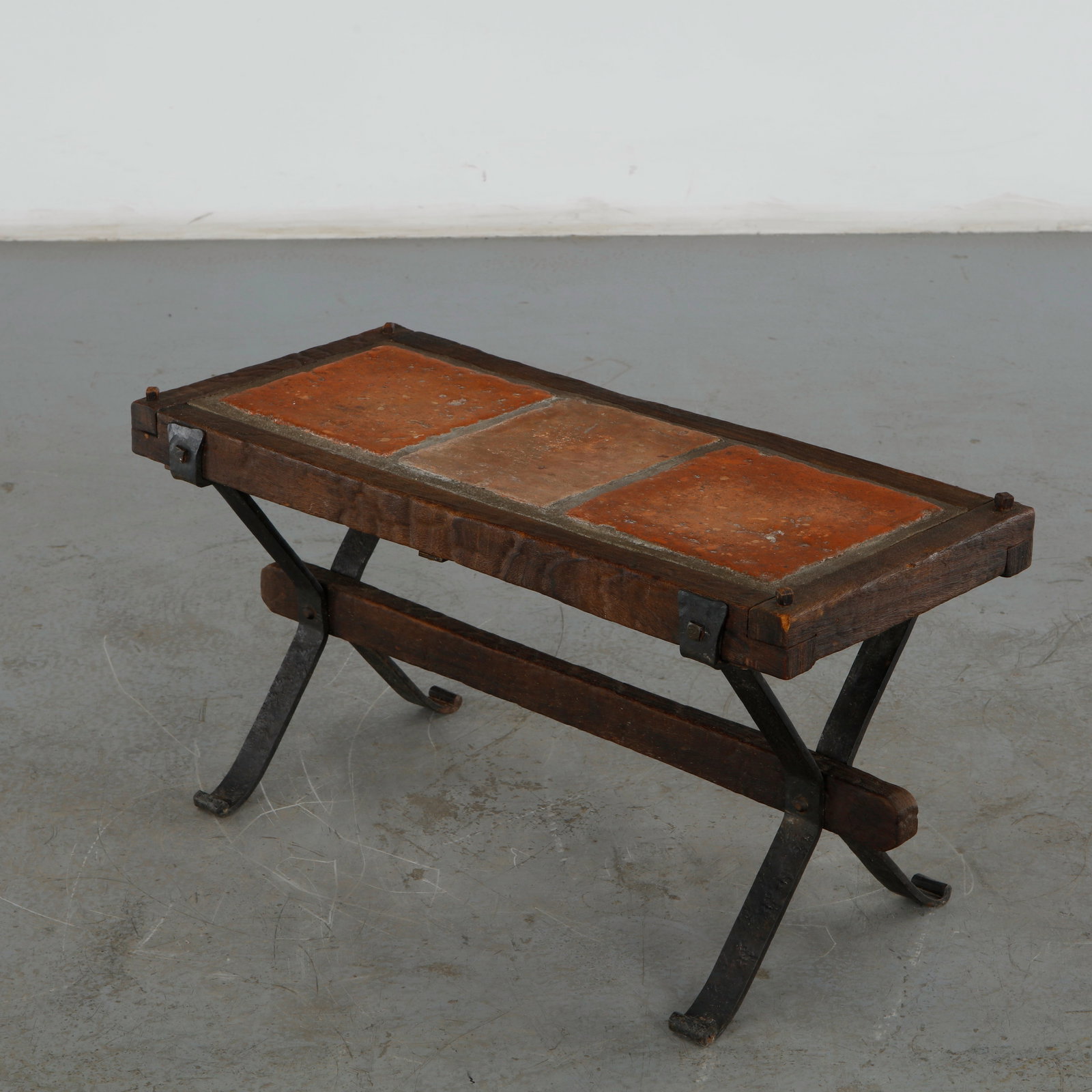 French Terracotta Tiles Wood Top Wrought Iron Coffee Table in the style of Roger Capron , 1960: This distinctive midcentury modern coffee table designed in a rustic, Brutalist manner heavily reminiscent of the iconic ceramic-and-wood pairings popularized by French designer Roger Capron. Height: