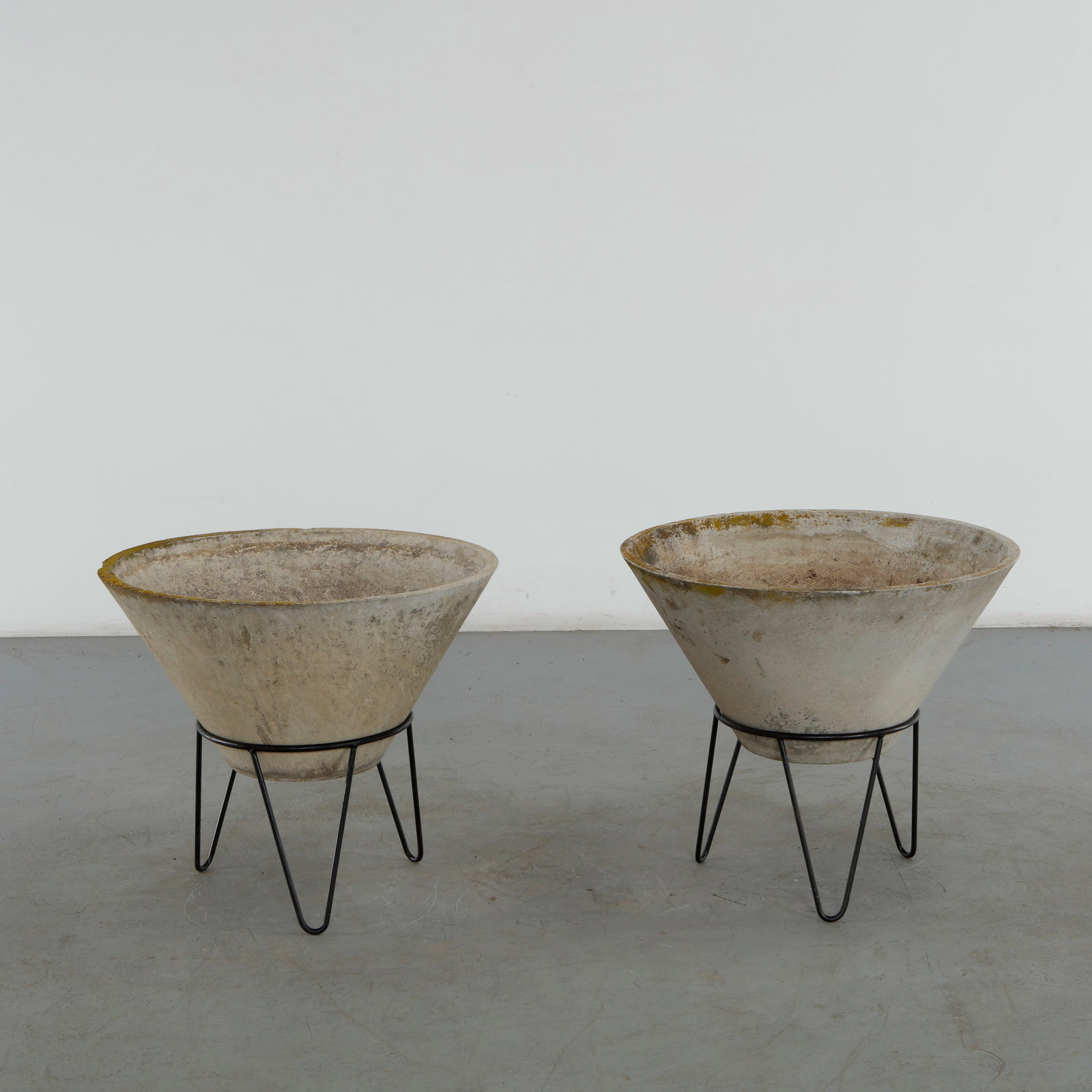 Willy Guhl, Pair of Large Conical Planters on Stands, 1960s: Iconic Willy Guhl silhouettes in large form, these conical planters rest atop minimalistic metal stands, weathered yet timeless. Height: 24 in. Diameter: 28.5 in. Condition Wear