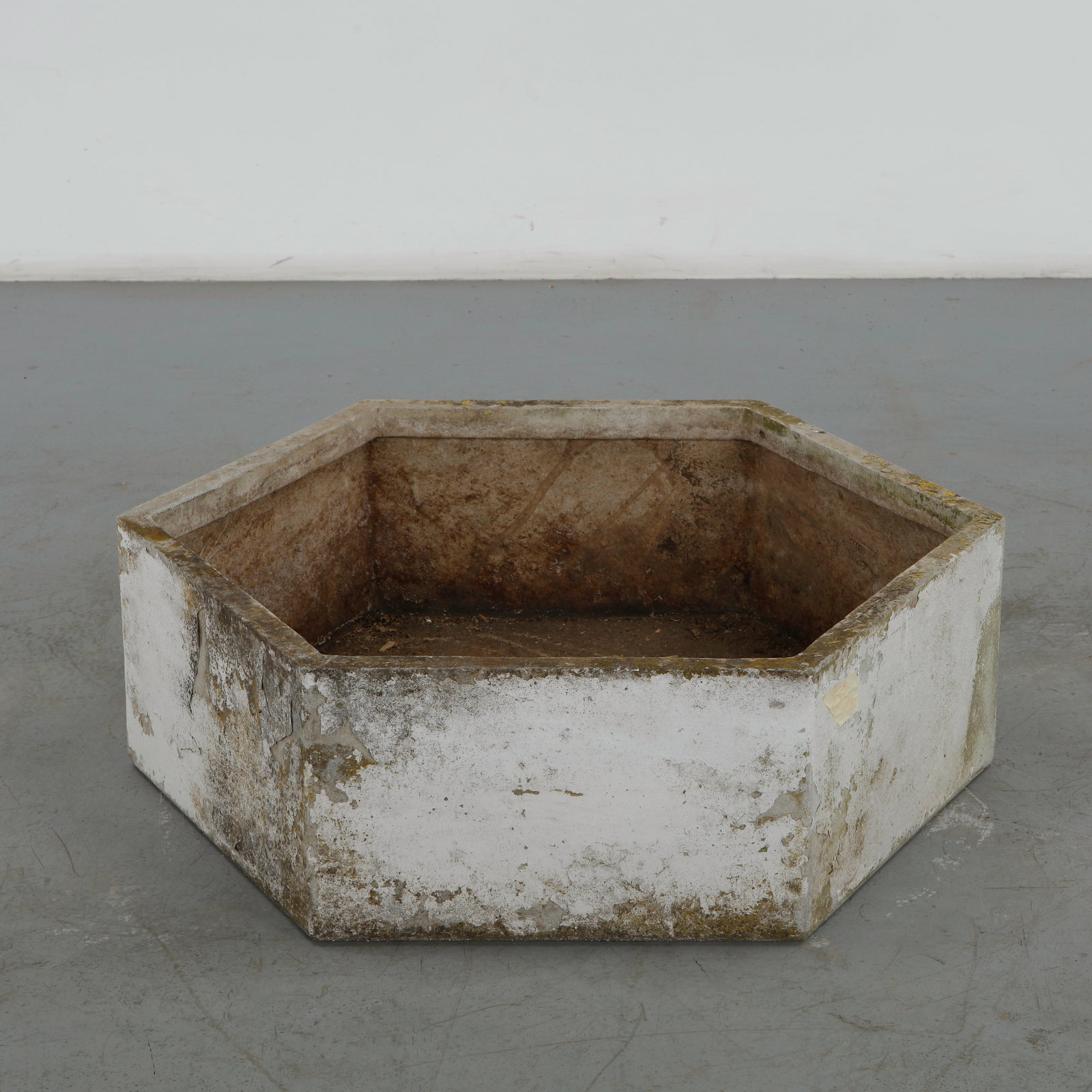Willy Guhl, Monumental Hexagonal Planter, 1960s: A massive concrete hexagonal planter designed by Swiss designer Willy Guhl. Its sculptural form and weathered patina give it a timeless industrial aesthetic. Height: 12 in. Length: 39.5 in. Width: 34