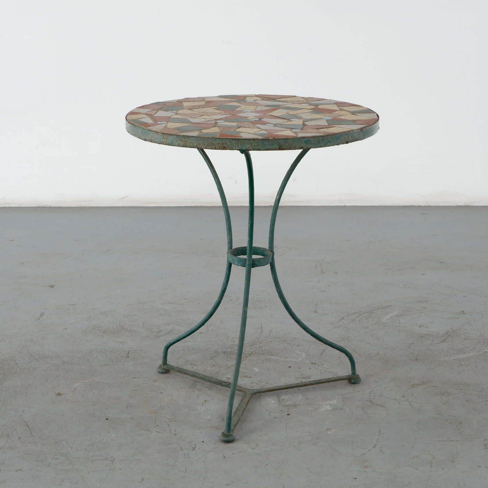 Mosaic Tile Outdoor Side Table, 1960s: This mosaic tile outdoor side table is a classic example of Mediterranean-style retro patio furniture. It balances hand-crafted stonework with a slender, mid-century iron frame. Height: 28.5 in.