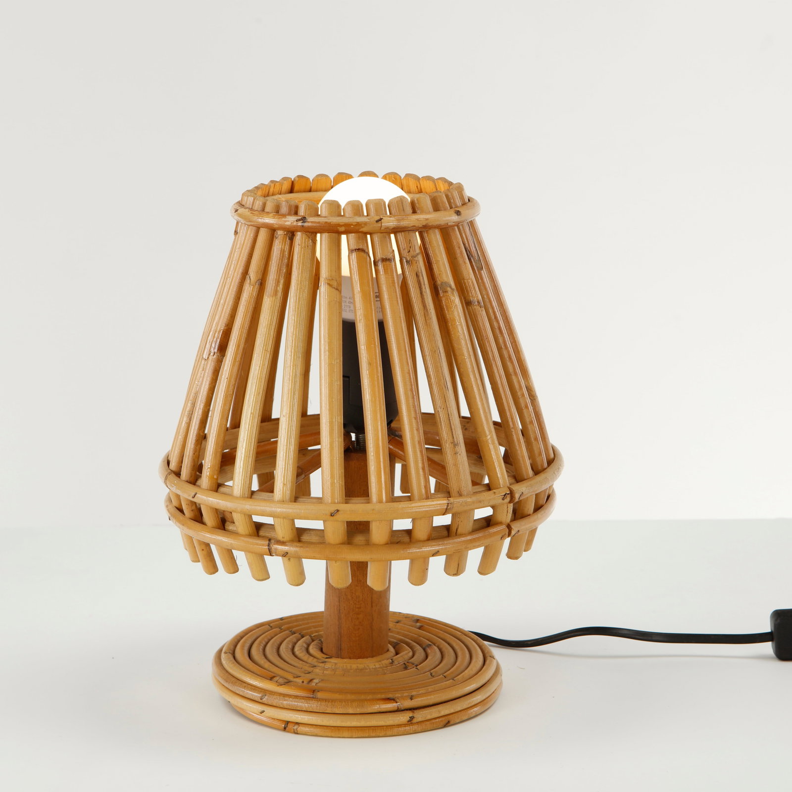 Louis Sognot, Rattan Cone Table Lamp, 1960s: This distinctive fixture is an authentic French Mid-Century Modern bamboo and rattan table lamp, meticulously crafted in the iconic style popularized by pioneering designer Louis Sognot during the