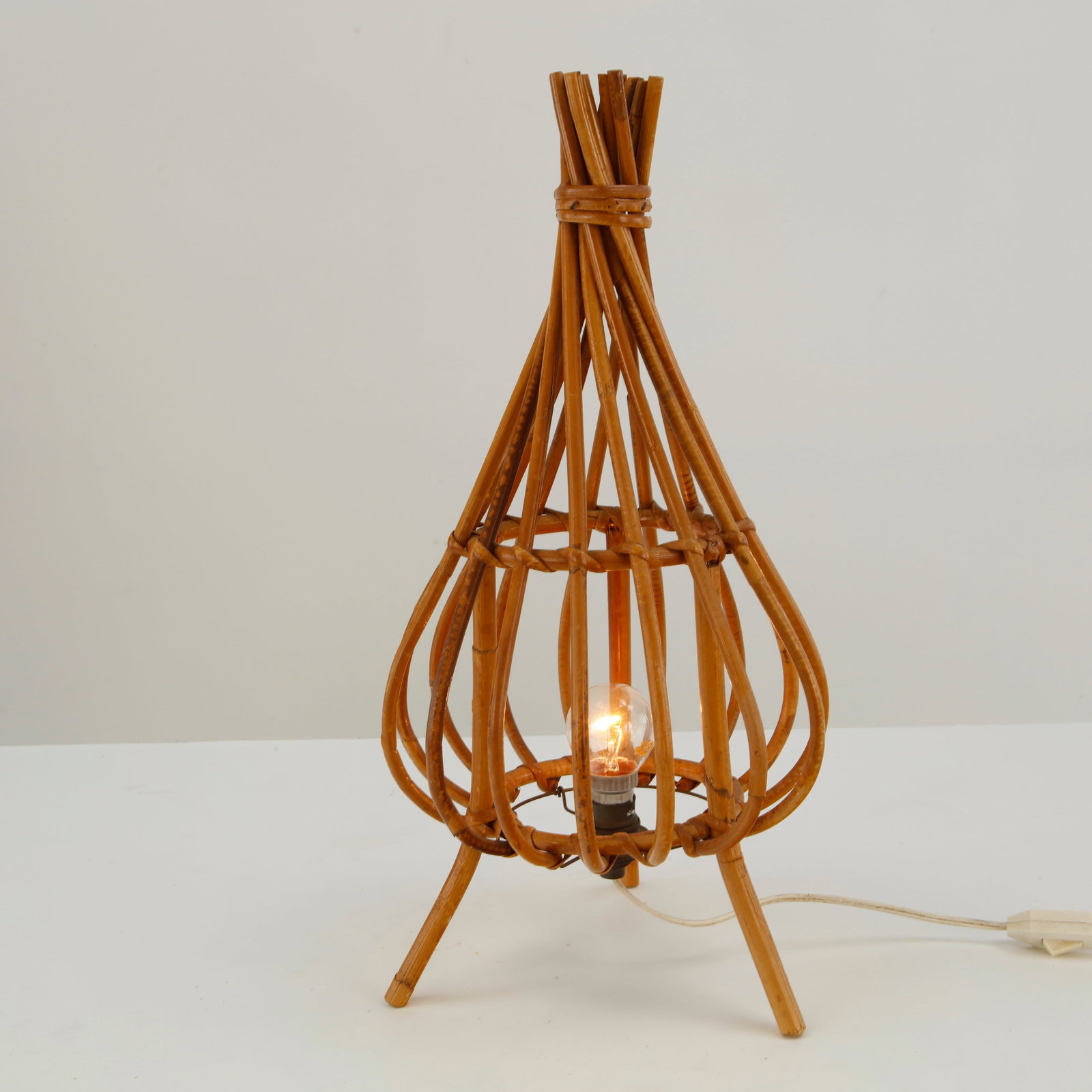 Louis Sognot, Rattan Teardrop Table Lamp, 1960s: This piece is a highly sought-after French Mid-Century Modern "Teardrop" or "Onion" rattan table lamp, designed by Louis Sognot. It is one of his most iconic and sculptural small