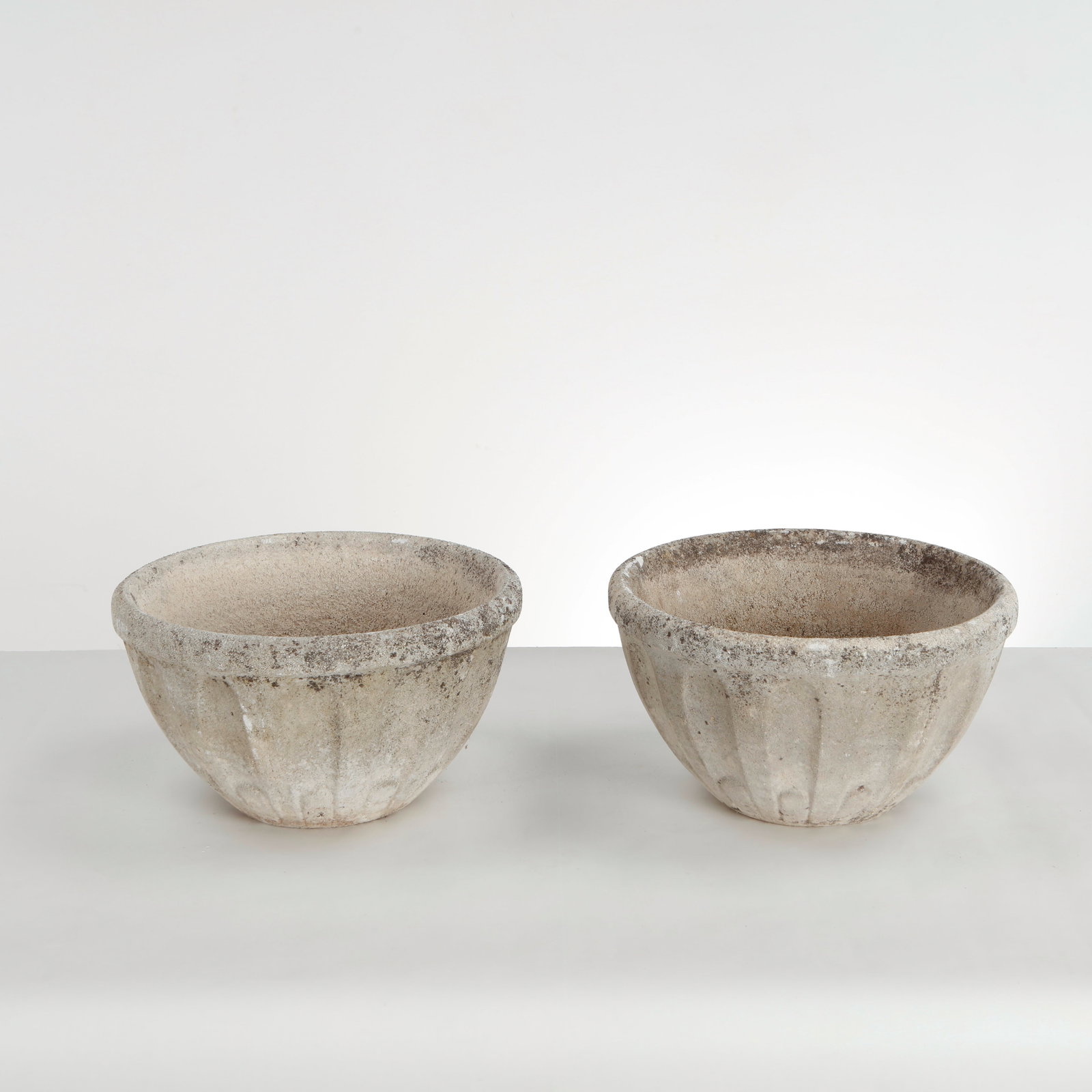 Pair of Round Stone Planters, 1960s: This pair of cast stone campana bowl planters is an excellent example of mid-century European classical revival garden design. Stripped of overly ornate detailing, they focus on pure architectural