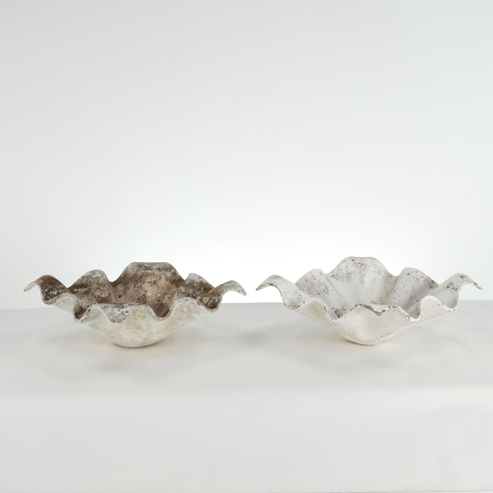 Willy Guhl, Pair of Small Elephant Ears Planters, 1960s: Pair of Small Elephant Ear planters, also known as handkerchief planters, by Willy Guhl for Eternit, Switzerland. Width: 19 in. Length: 19 in. Height: 7 in. Condition Wear commensurate