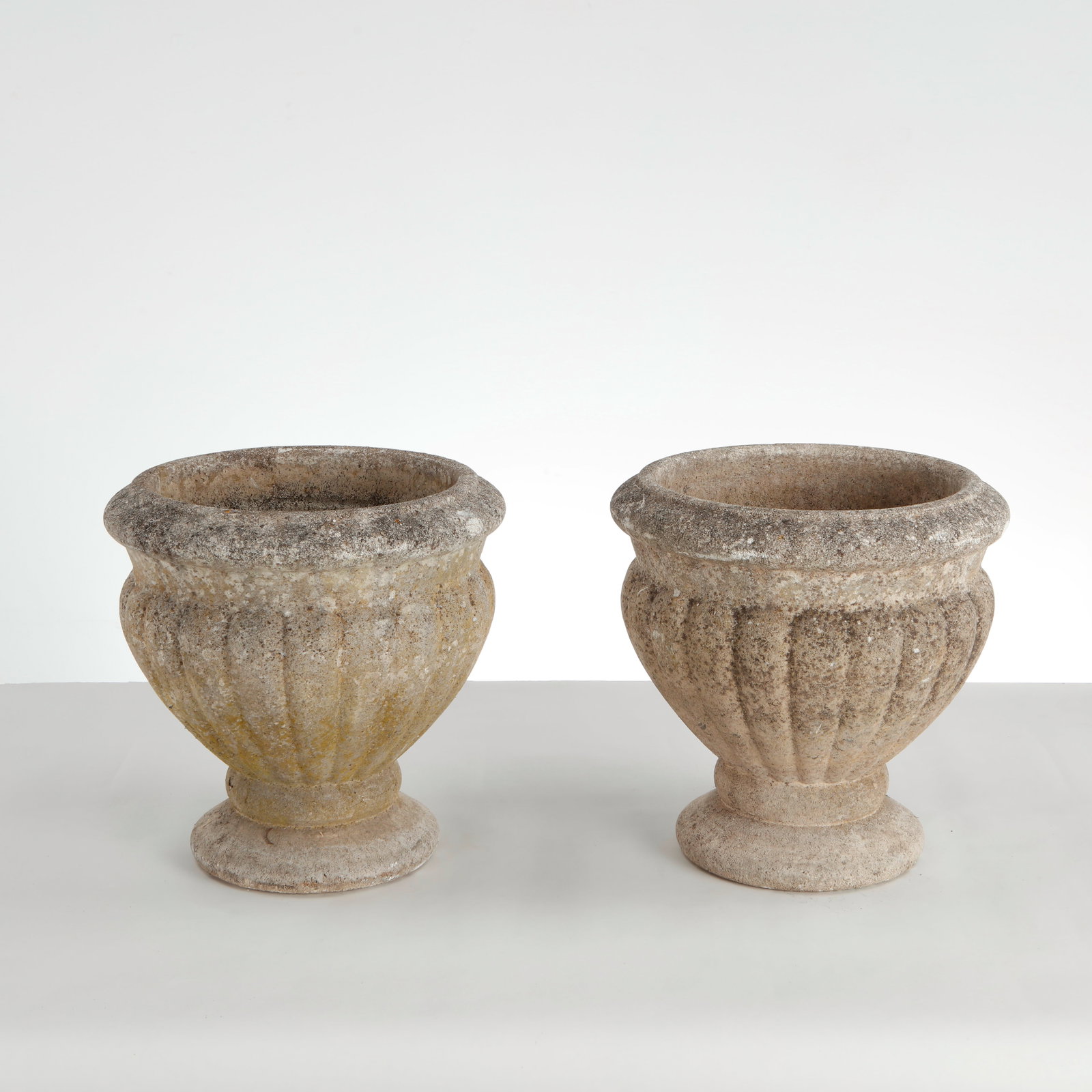 Grandon Fres, Pair of Round Stone Planters, 1960s: This pair of vintage cast stone campana urn planters_produced by the renowned French manufacturer Grandon Fr?res_is a beautiful example of classical European revival garden ornamentation. Styled with 