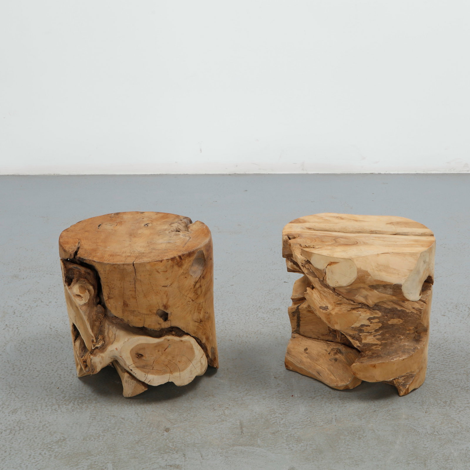 Pair of Handcraved Solid Wood Stools: This pair of stools is carved from solid burl wood, each retaining the organic, hollowed form and rich figuring of the natural trunk. The rugged, sculptural silhouette and warm grain highlight the