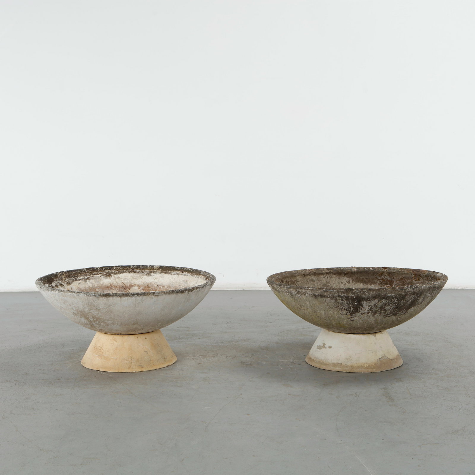 Willy Guhl, Pair of Bowl Planters on Stands, 1960s: Pair of round planters by Swiss designer Willy Guhl for Eternit, showcasing a magnificent patina. Elevated on their original concrete stands, creating a majestic and commanding presenceHeight: 18 in.