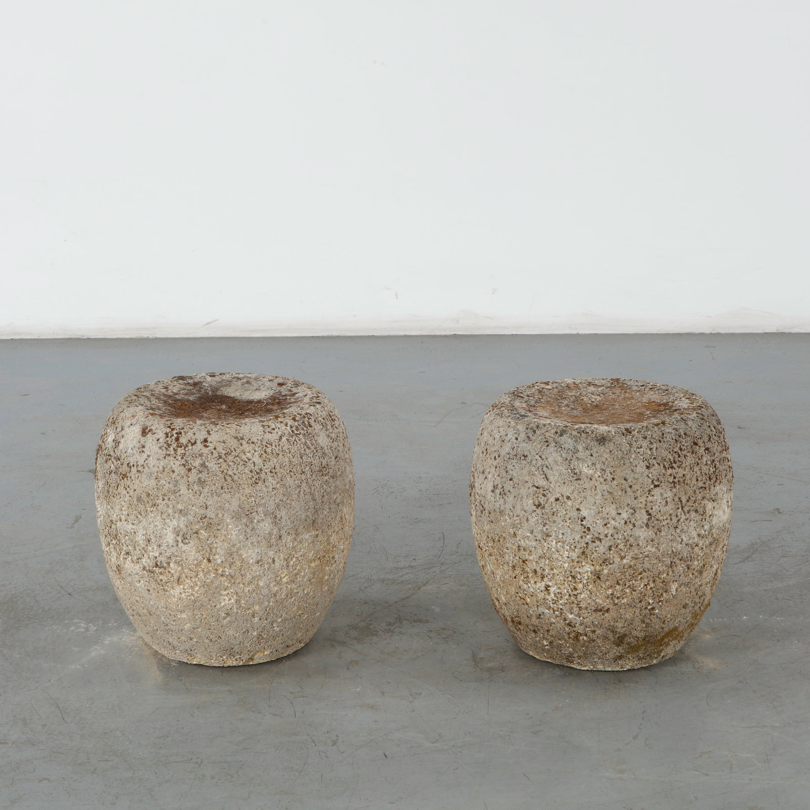 Pair of Round Stone Stools, 1960s: This pair of mid-century brutalist cast stone garden stools, crafted in the 1960s, features a raw, organic form that bridges the gap between functional furniture and minimalist outdoor sculpture.