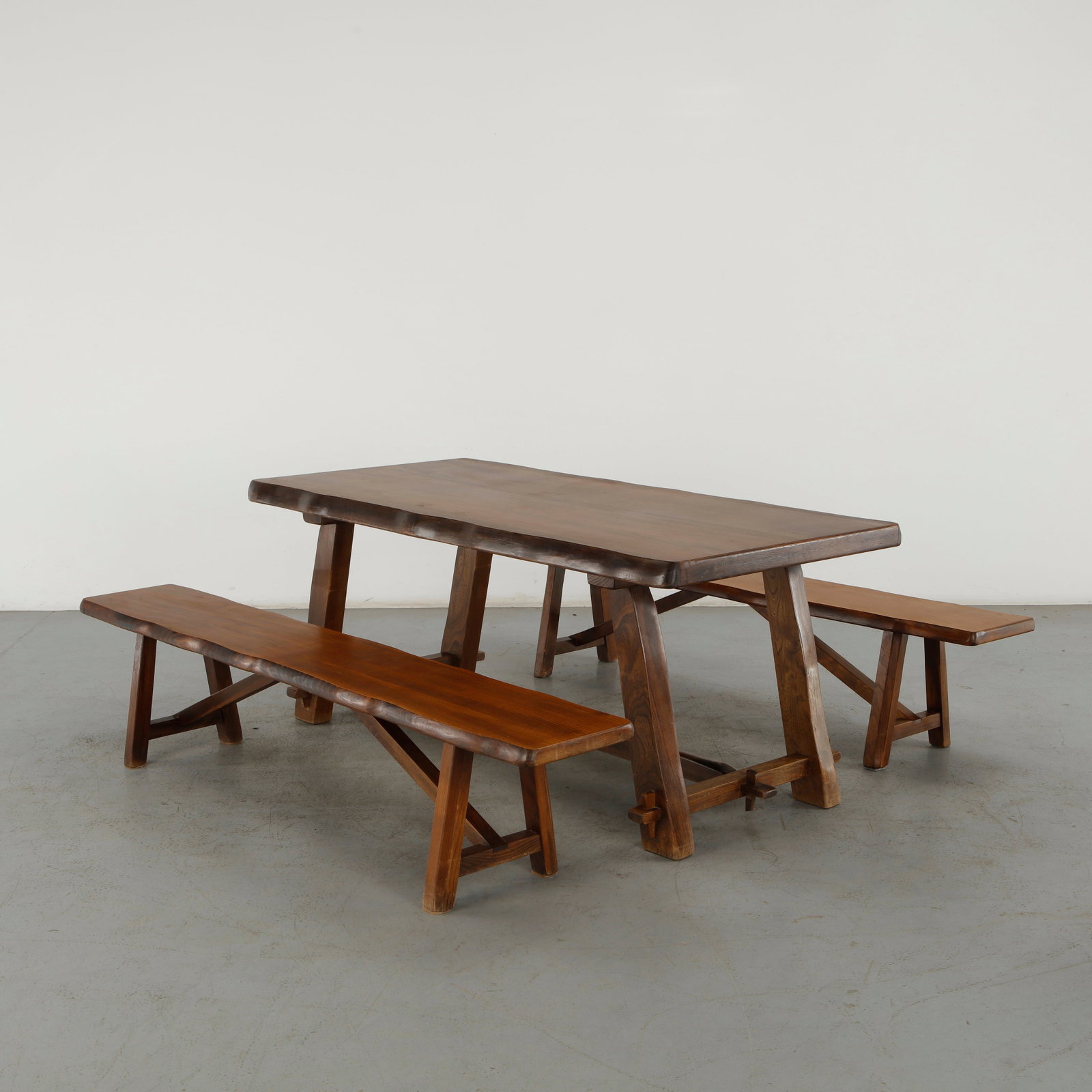 Olavi Hanninen, Dining Table and Benches, 1960s: This solid dining set by Olavi H_nninen is a landmark example of Finnish brutalist and mid-century modernist design. H_nninen was a pioneer in showcasing the raw, unrefined power of wood, and this mat