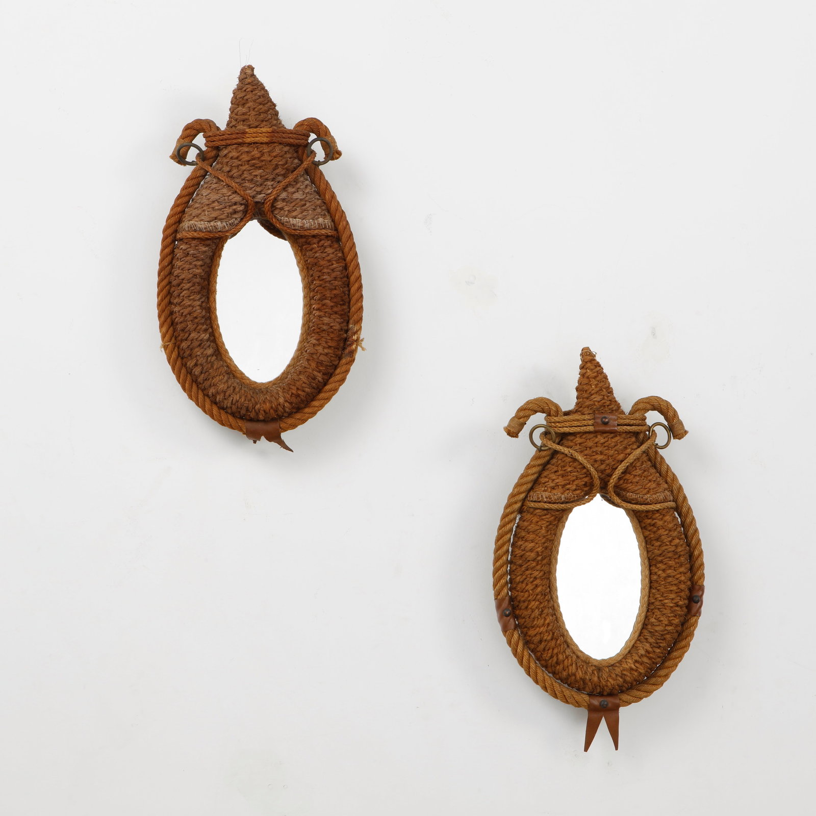 Audoux Minet, Pair of Small Rope Mirrors, 1960s: A rare pair of wall mirrors by Audoux Minet, handwoven in natural rope with sculptural teardrop frames and distinctive nautical detailing. Executed with braided cord, leather accents, and metal