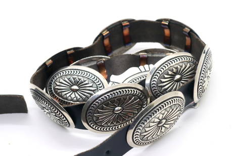 Navajo Artist Dale Morgan Sterling Concho Belt: Navajo artist Dale Morgan hand-tooled, oxidized sterling silver concho belt 37", (1) buckle size L 3"x 2" W, (11) L 2 1/4" x W 1 1/2". One of a kind.