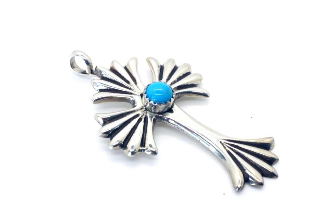 Navajo Artist Keith James Turquoise Cross: Navajo artist Keith James turquoise Cross. - Sterling silver with Sleeping Beauty Turquoise center stone, 1/4" round. The Cross is L 2"X 1" W. Bale is 3/16". Signed. One of a kind.