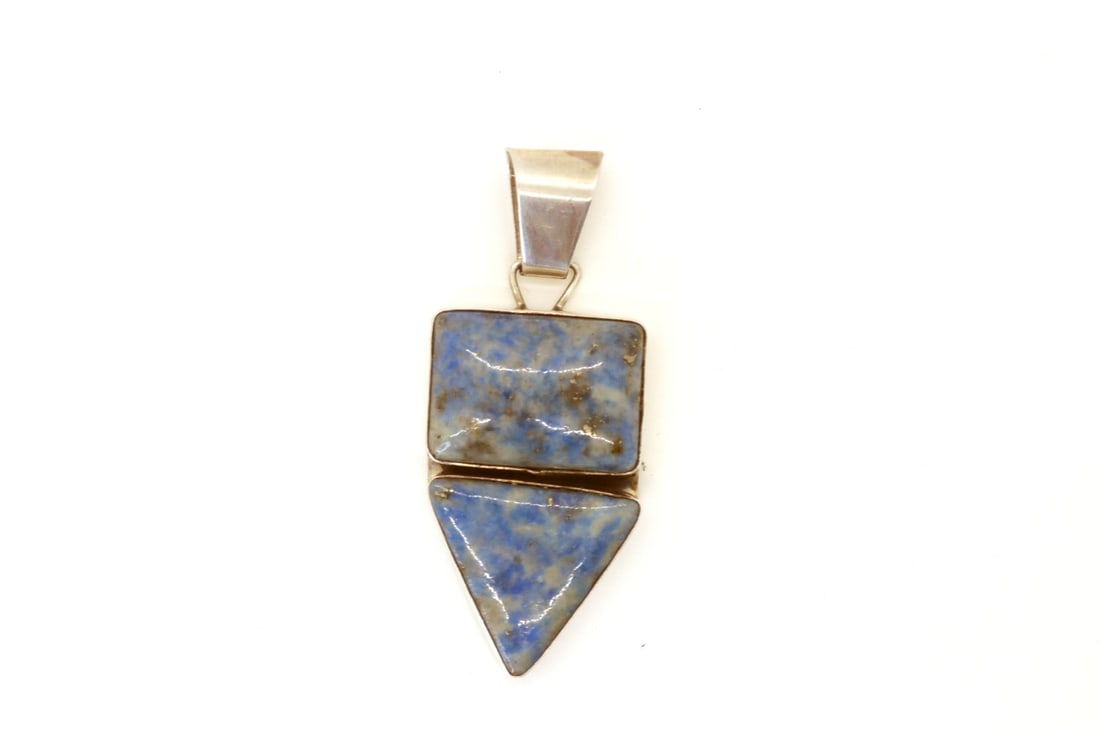 Vintage Gilbert " DINO" Garcia Denim Lapis Pendant: Vintage Gilbert " DINO" Garcia denim lapis pendant (2) stone, top rectangle L 1'x3/4"W, bottom triangle 1" x 1 "x 1". OAL 2 1/2". Bale 3/8". One of a kind.