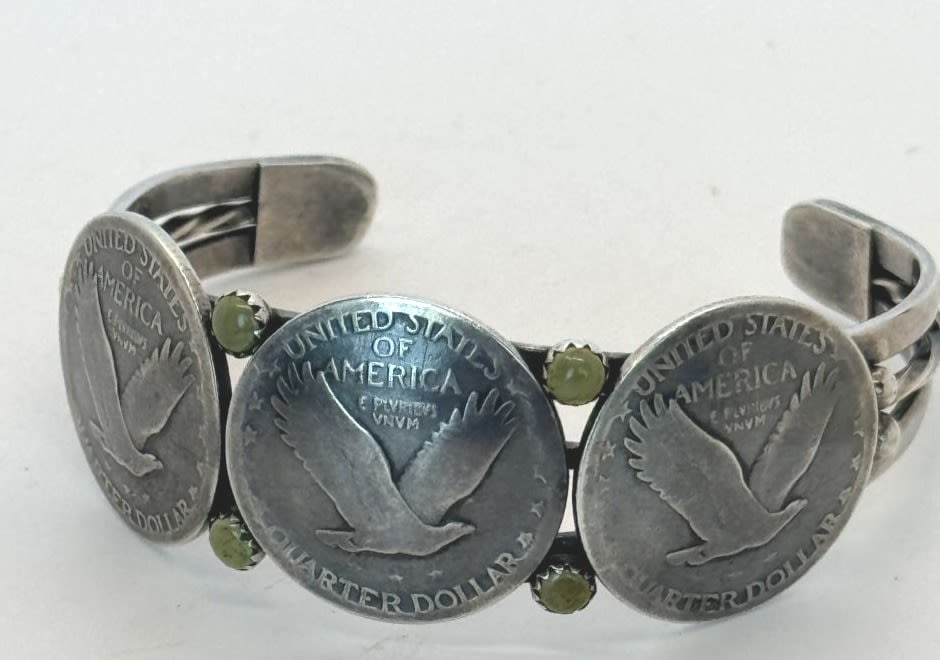 Vintage Navajo Quarter Dollar Cuff: Native American Navajo Quarter Dollar sterling silver cuff bracelet with (4) 4mm mounted Gaspeite gemstones. Signed Buffalo Dancer. Size 6 3/4" Gap 1 1/4" Width 7/8" and tapers to 1/4". 37.58 gr