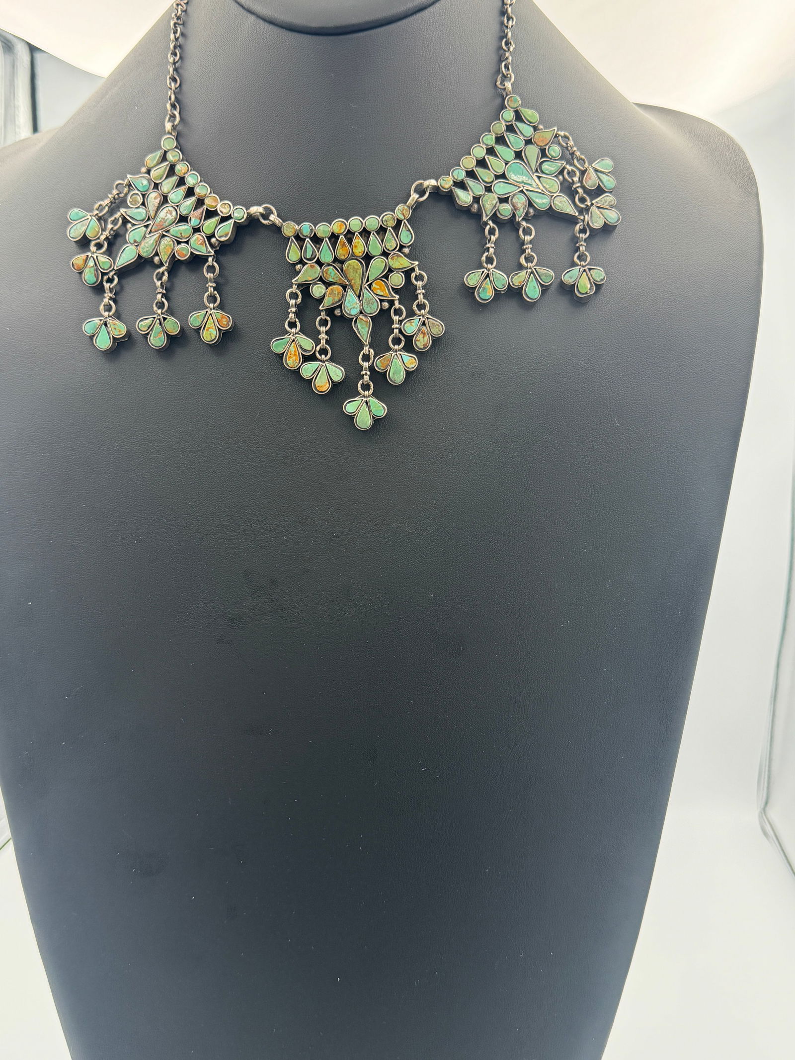 Vintage Petit Point Chandelier Necklace: Extraordinary vintage Native American Navajo sterling silver 3 panel petit point chandelier necklace with hand tooled chain links and round and tear drop Green Kingman Turquoise bezel set gemstones. T