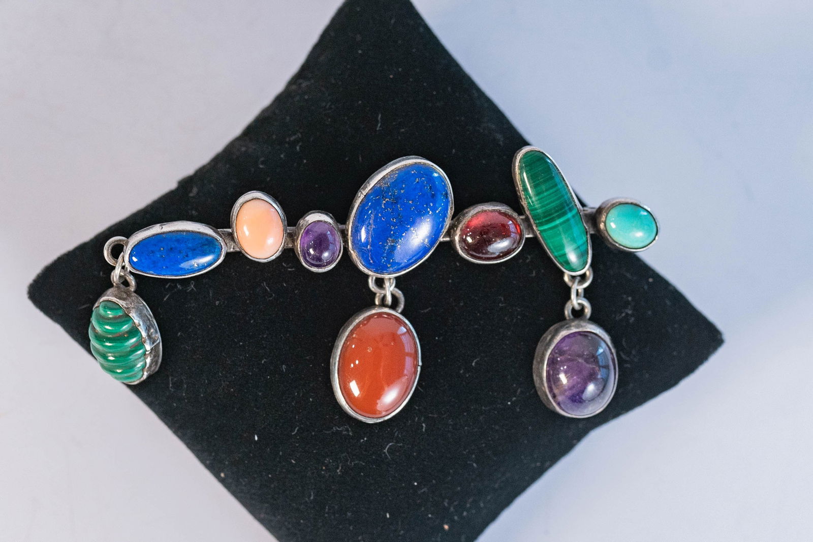 Vintage Nakai Gemstone Pin: Native American Navajo master silversmiths Nakai sterling silver vintage pin featuring Malachite, Afghanistan Lapis, Pink Coral, Amethyst, Amber, Garnet and Sleeping Beauty Turquoise gemstones in vari