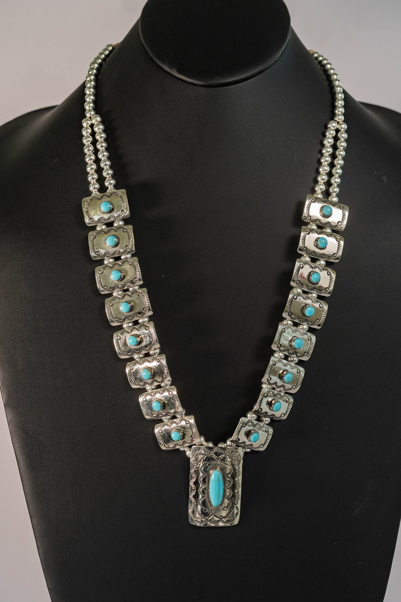 Beautiful Turquoise Blossom Necklace: Native American Navajo master silversmith Joseph Begay beautiful German Silver blossom necklace hand tooled and hand stamped with AAAA Sleeping Beauty Turquoise gemstones. There are (16) blossoms L 5/