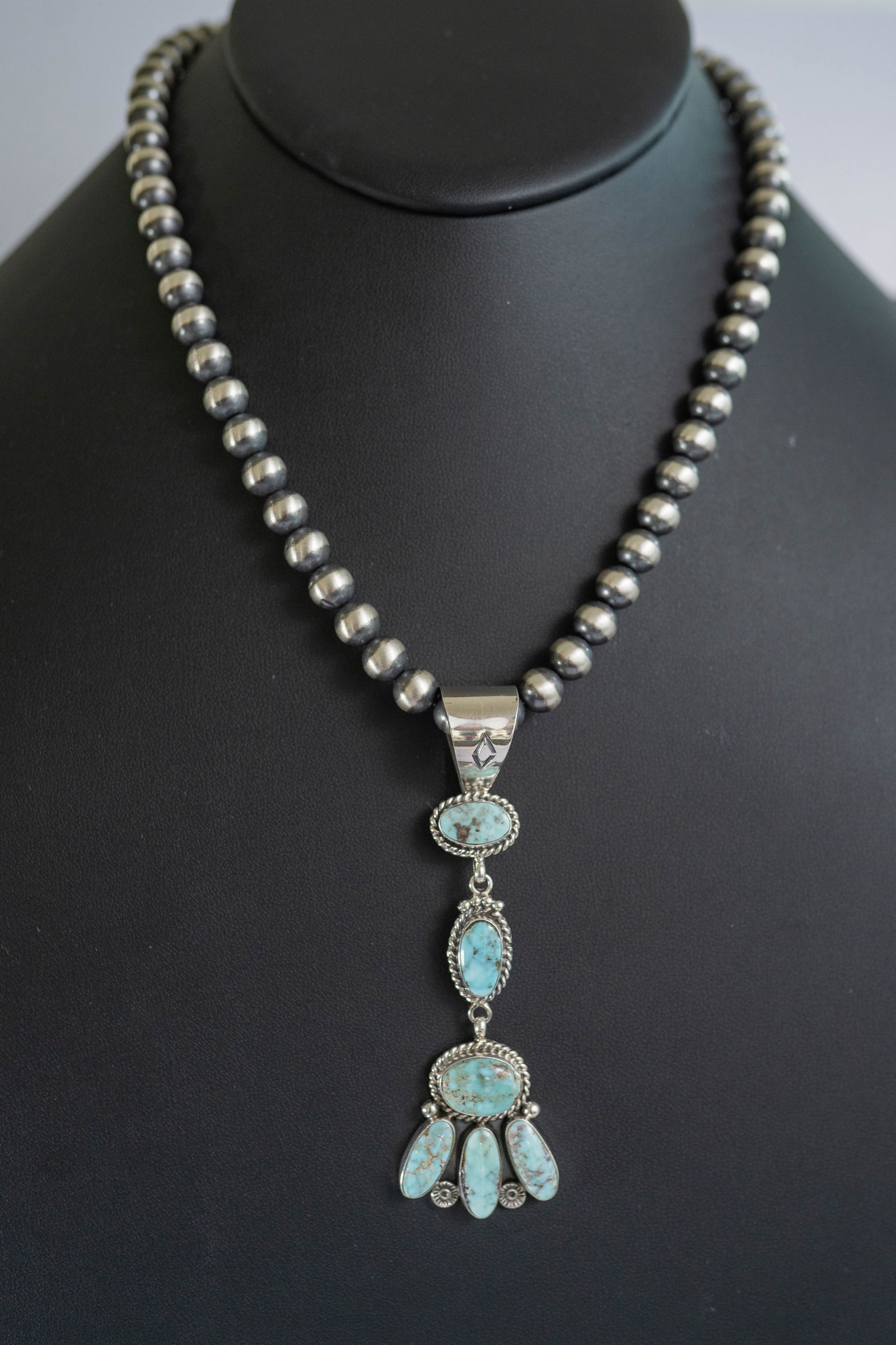 Extraordinary Carico Lake Pendant Necklace: Native American Navajo master silversmith Ella Linkin extraordinary sterling silver pendant featuring AAAAA rare Carico Lake Turquoise gemstones with twisted wire, rosette spacers and dot appliques. T