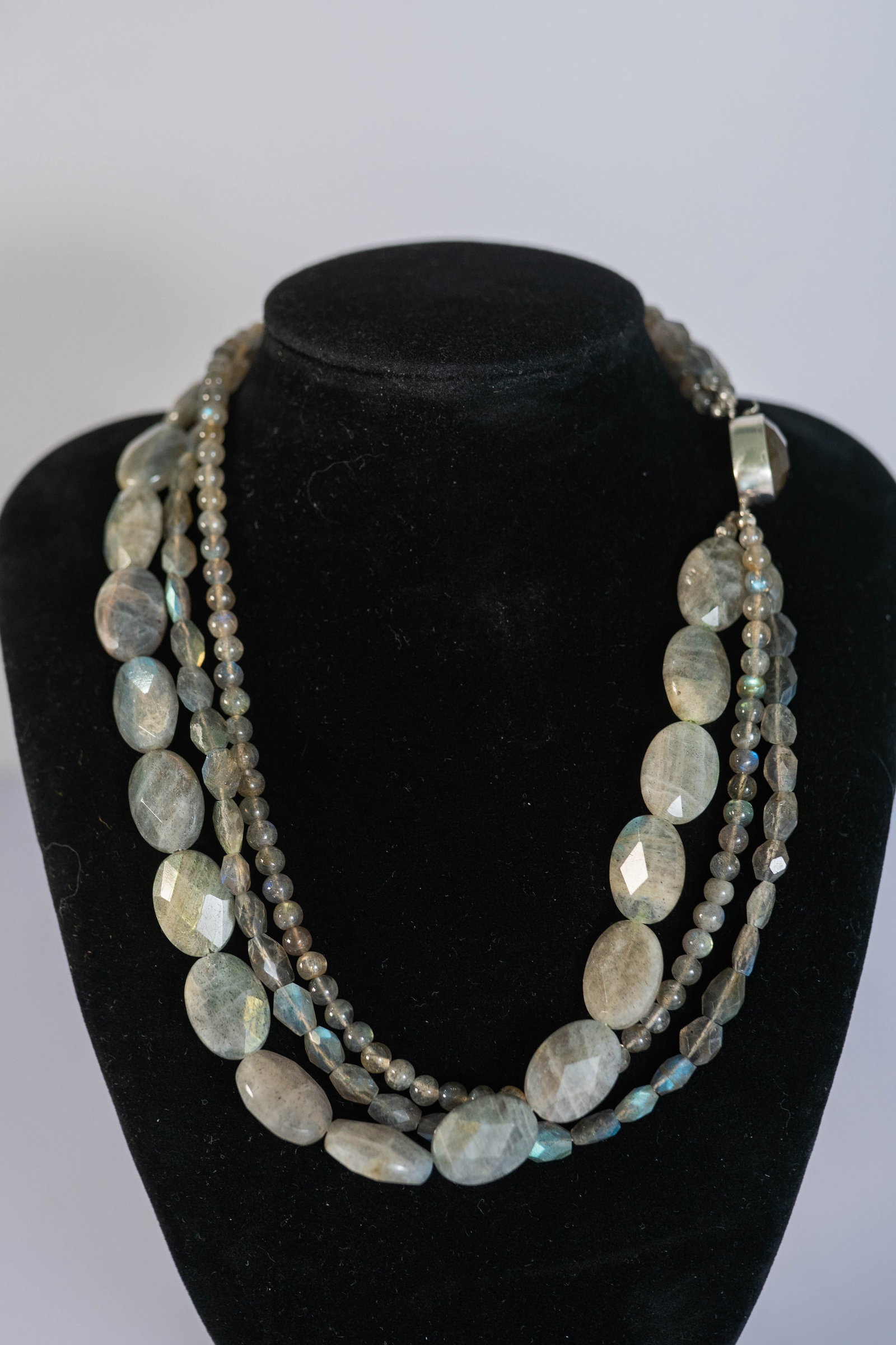 Gorgeous Three Strand Labradoroite Necklace: Gorgeous three strand Labradorite necklace featuring AAAAA faceted oval gemstones and polished round gemstones with a AAAAA faceted oval Labradorite and sterling silver clasp. L16 1/2 "