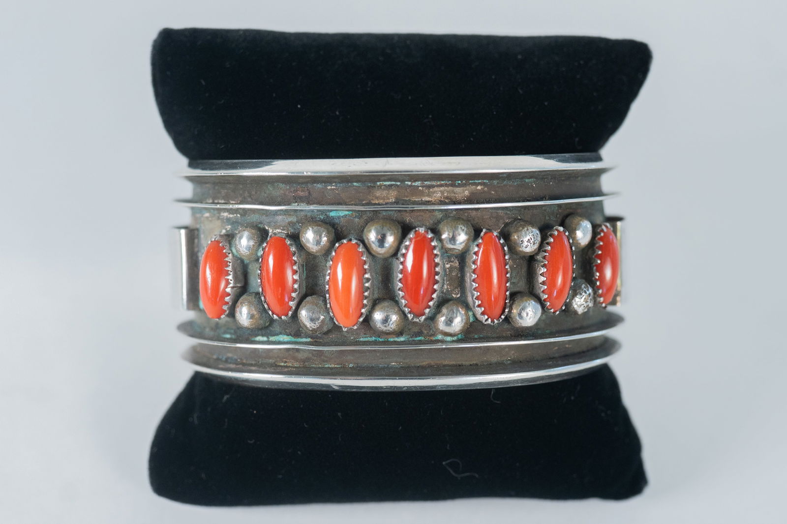 Alice Sam Important Vintage Channel Cuff Bracelet: Native American Navajo master silversmith Alice Sam important highly collectible sterling silver oxidized channel cuff featuring (7) AAAA Mediteranean Coral oval gemstones This is a superior piece Siz