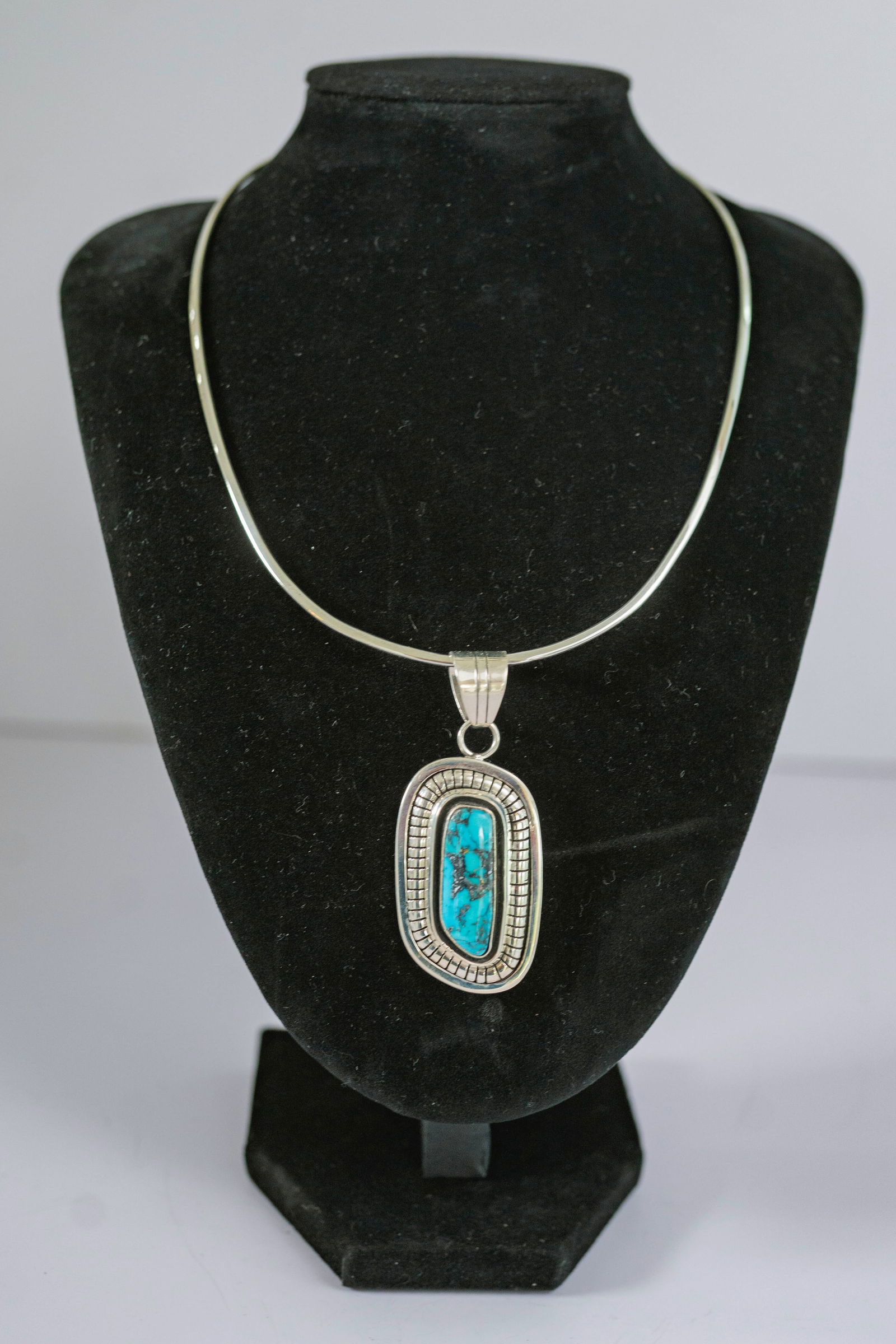 Breathtaking Persian Turquoise Pendant Necklace: Native American Navajo Master silversmith Marion Nez sterling silver hand tooled pendant which features a breathtaking AAAAA Persian Turquoise gemstone beautifully show cased in a contemporary