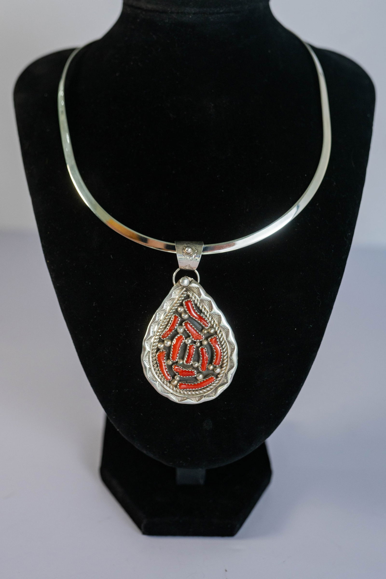 Vintage Mediterranean Coral Pendant Necklace: Native American Navajo Vintage sterling silver pendant hand tooled and hand stamped with 10 Mediterranean coral gemstones sterling silver bead appliques and twisted wire pendant is on a the pendant