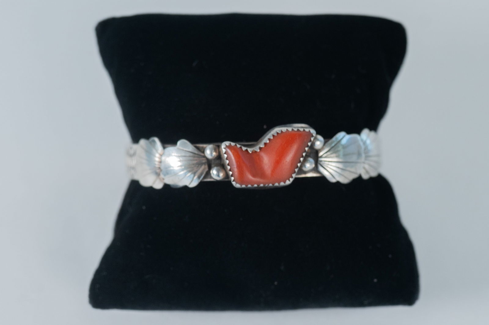 Unique Vintage Coral Cuff Bracelet: Native American Navajo unique vintage sterling silver cuff bracelet which features a Mediterranean coral center gemstone flanked by berry and leaf appliques and an intricate hand stamped design which