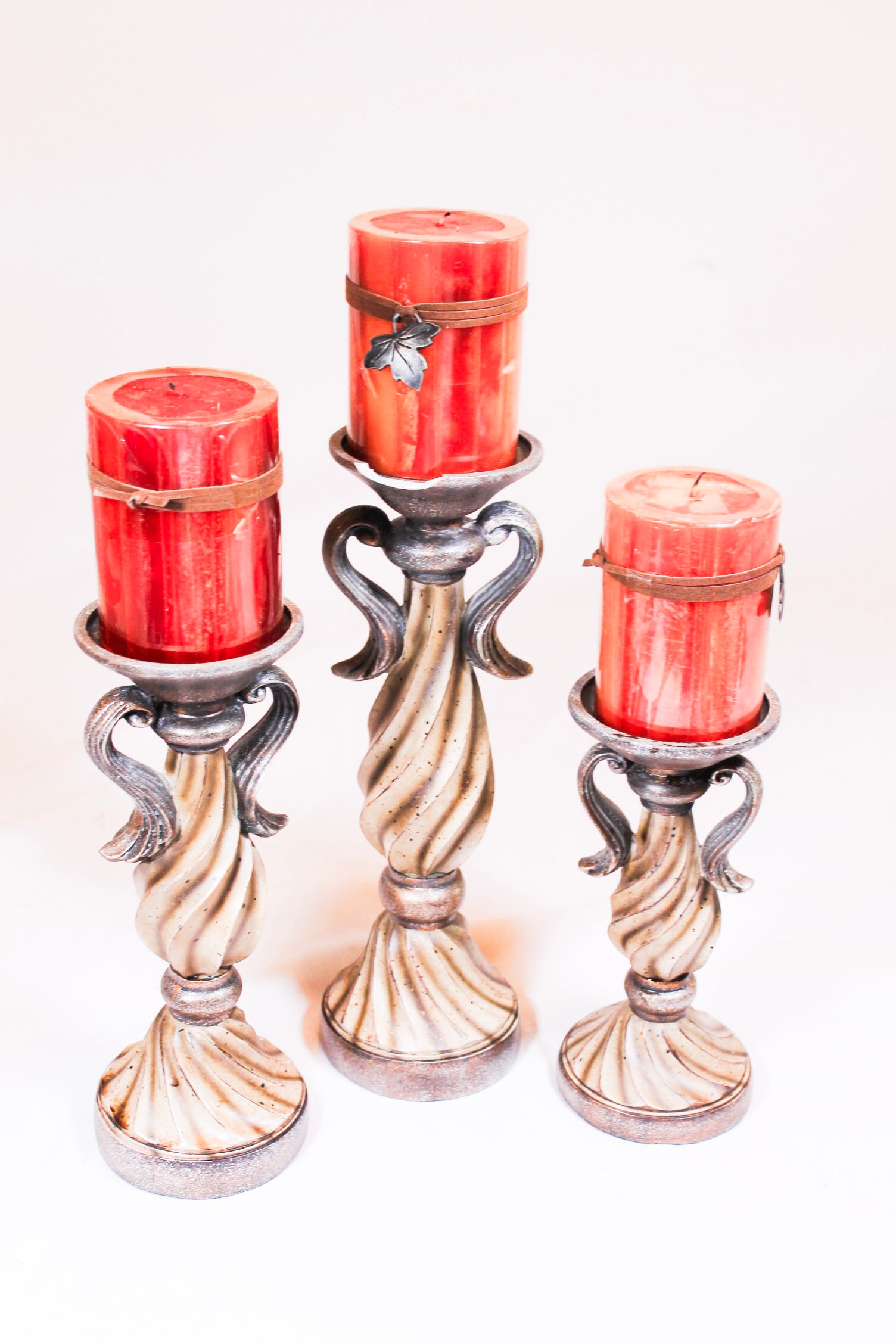 Decorative bronze candlestick set with red candles: Decorative bronze candlestick set with red candles