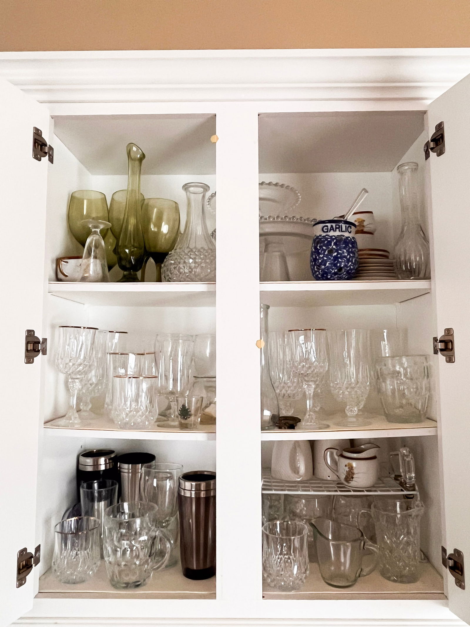 Cabinet with decorative clear glassware and green tint glasses (1 of 1)