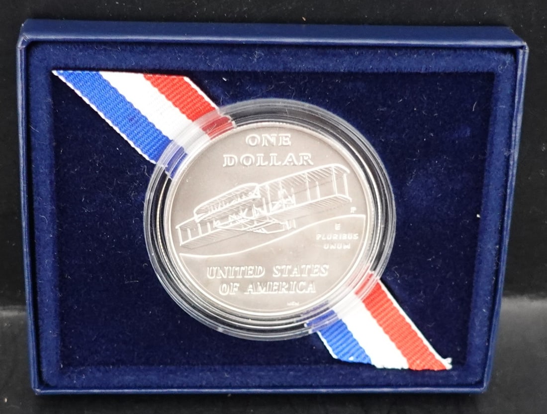 2003 First in Flight Commemorative Coin: This is in the Mint box and Exceptional! Low Estimate: 80High Estimate: 100