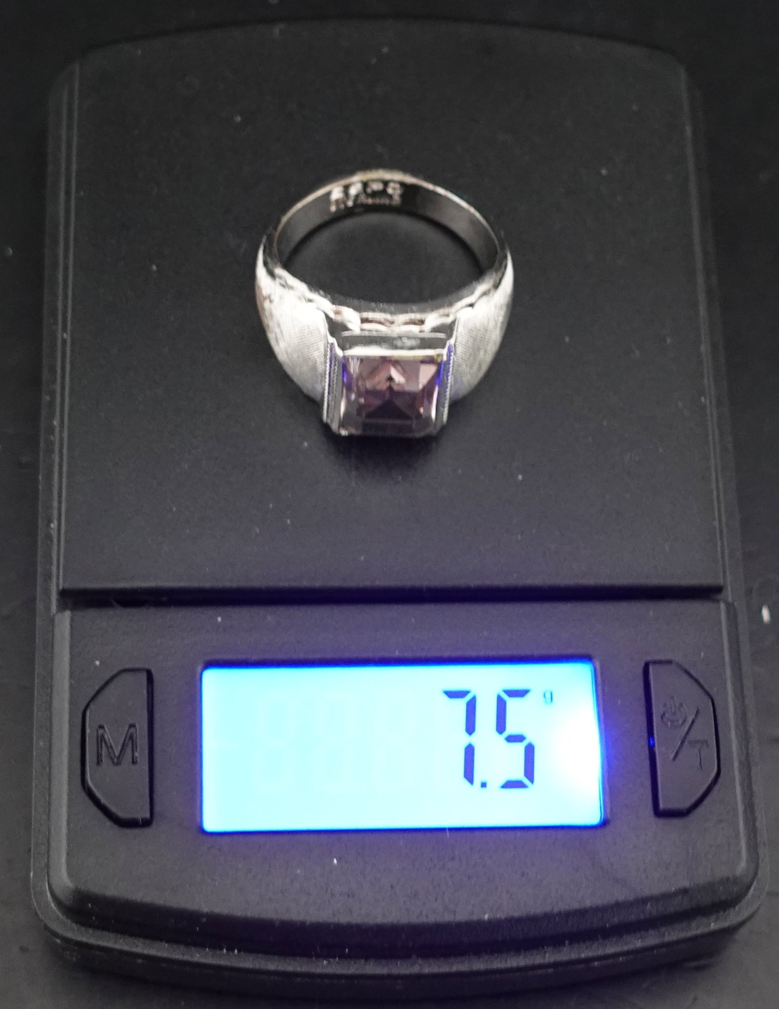 Silver and Amethyst Ring: The Weight is 7.5g of Sterling Silver. It is Marked as Sterling. The Gem Appears to be Amethyst. Looks to be Size 8 Low Estimate: 30.00 High Estimate: 50.00