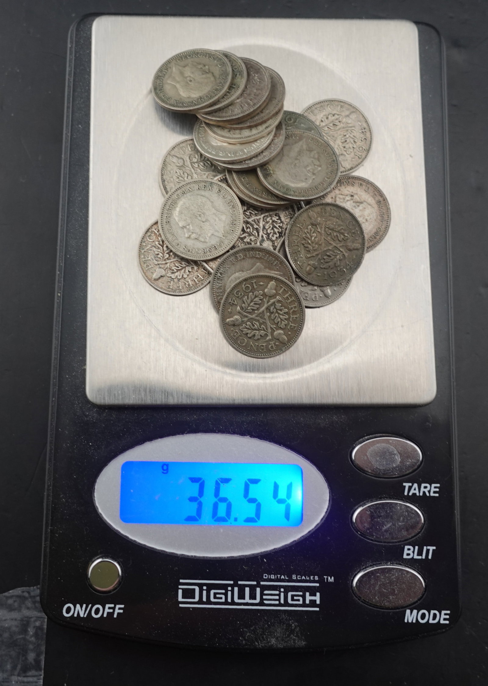 Lot of Silver Coins: (1) Silver Canadian Quarter (22) Silver 3 Pence Coins Low Estimate: 60.00 High Estimate: 80.00