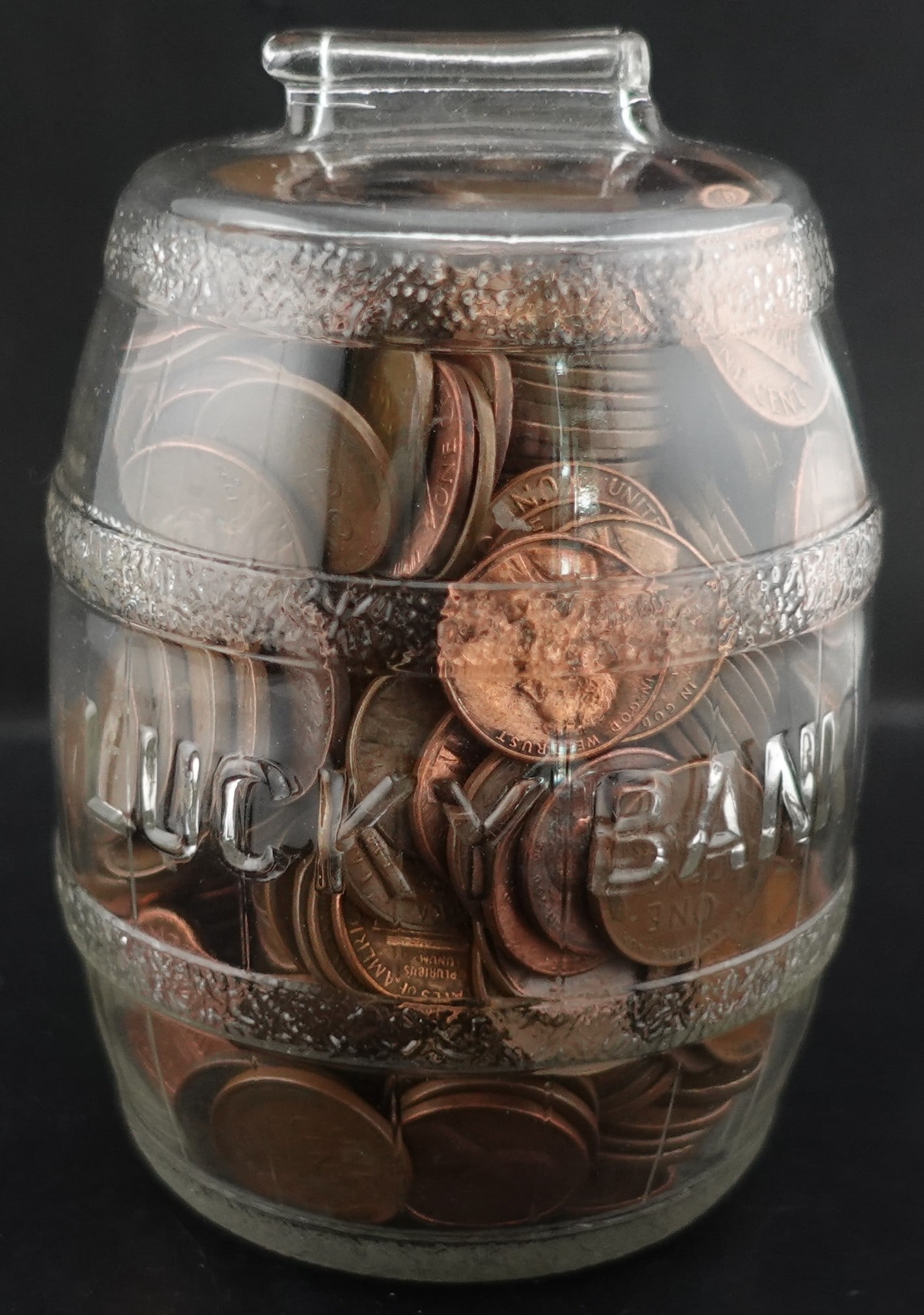 Old Glass Piggy Bank With Coins: There are wheat and Lincoln cents.
