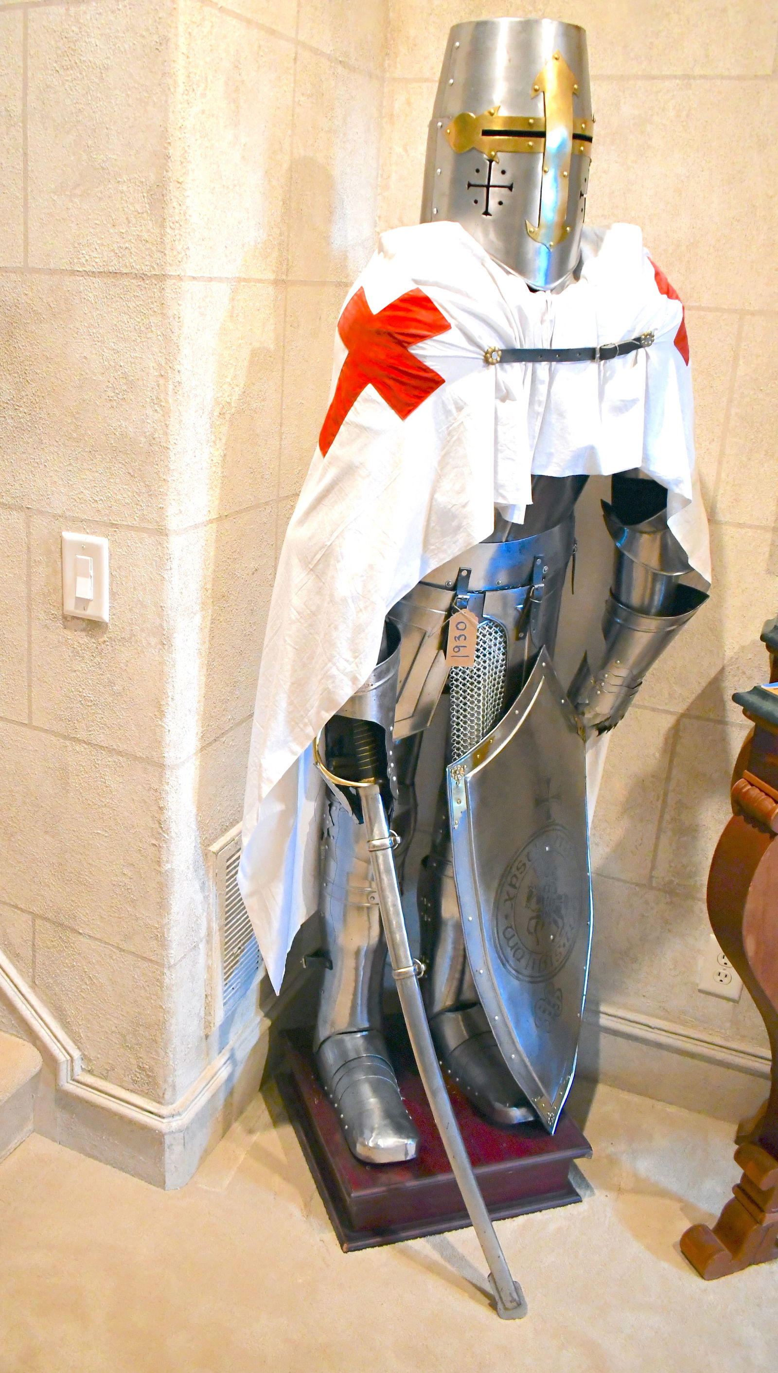 Contemporary Suit Of Knight's Armor With White Flag And Red Cross: 75" tall x 31" wide x 24" deep Stands on brown wooden base Includes shield and sword