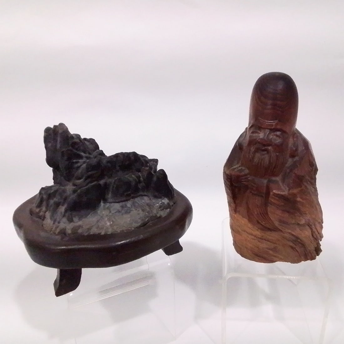Chinese Carved Wood Figure Depicting Confucius: A Chinese Carved Wood Figure Depicting Confucius, 20th Century, Together with a scholar's stone on a wooden stand. Tallest dimensions: H: 5 1/2 x W: 2 3/4 x D: 2 1/2 in.