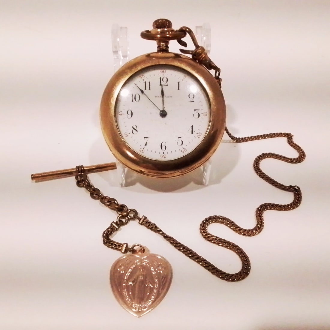Walthan Gold Plated Pocket Watch Warranted 20 Years: A Walthan Gold Plated Pocket Watch Warranted 20 Years, Fifteen jewels. With gold plated watch chain and Holy Mary charm.