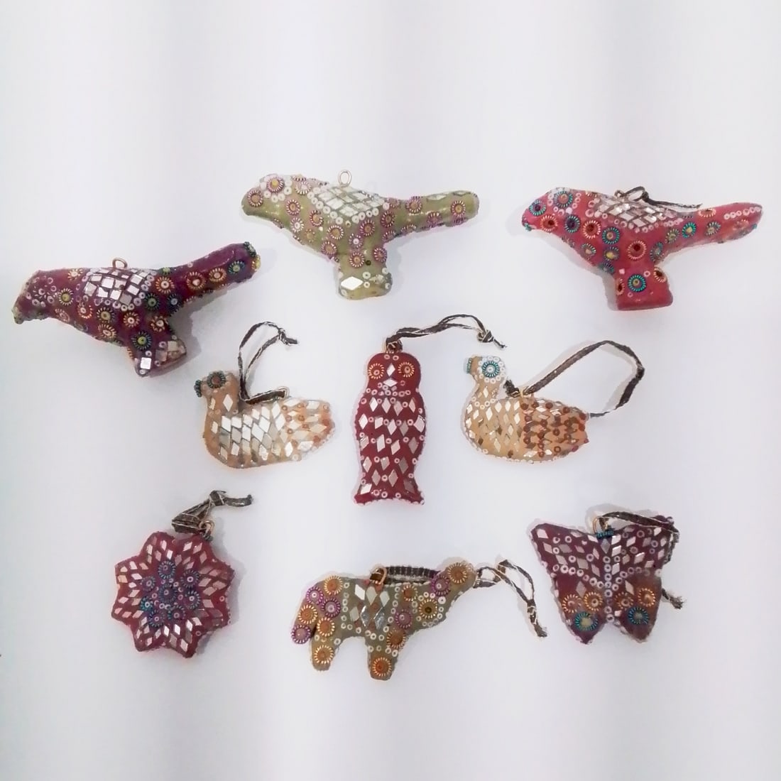 Nine Indian Beaded Clay Ornaments: A Group of Nine Indian Beaded Clay Ornaments, 20th Century. Largest dimensions: H: 2 x W: 3 3/4 x D: 1 in.