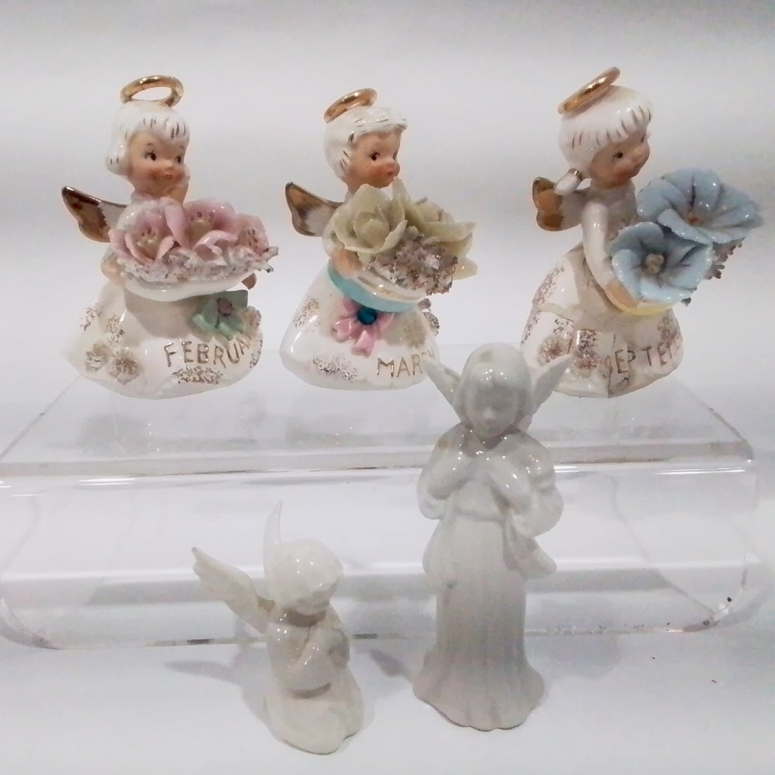 Five Vintage Porcelain Angel Figurines: A Collection of Five Vintage Porcelain Angel Figurines, 20th Century, Three by George Z. Lefton for February, March and September. Largest dimensions: H: 4 x W: 3 x D: 2 1/8 in.