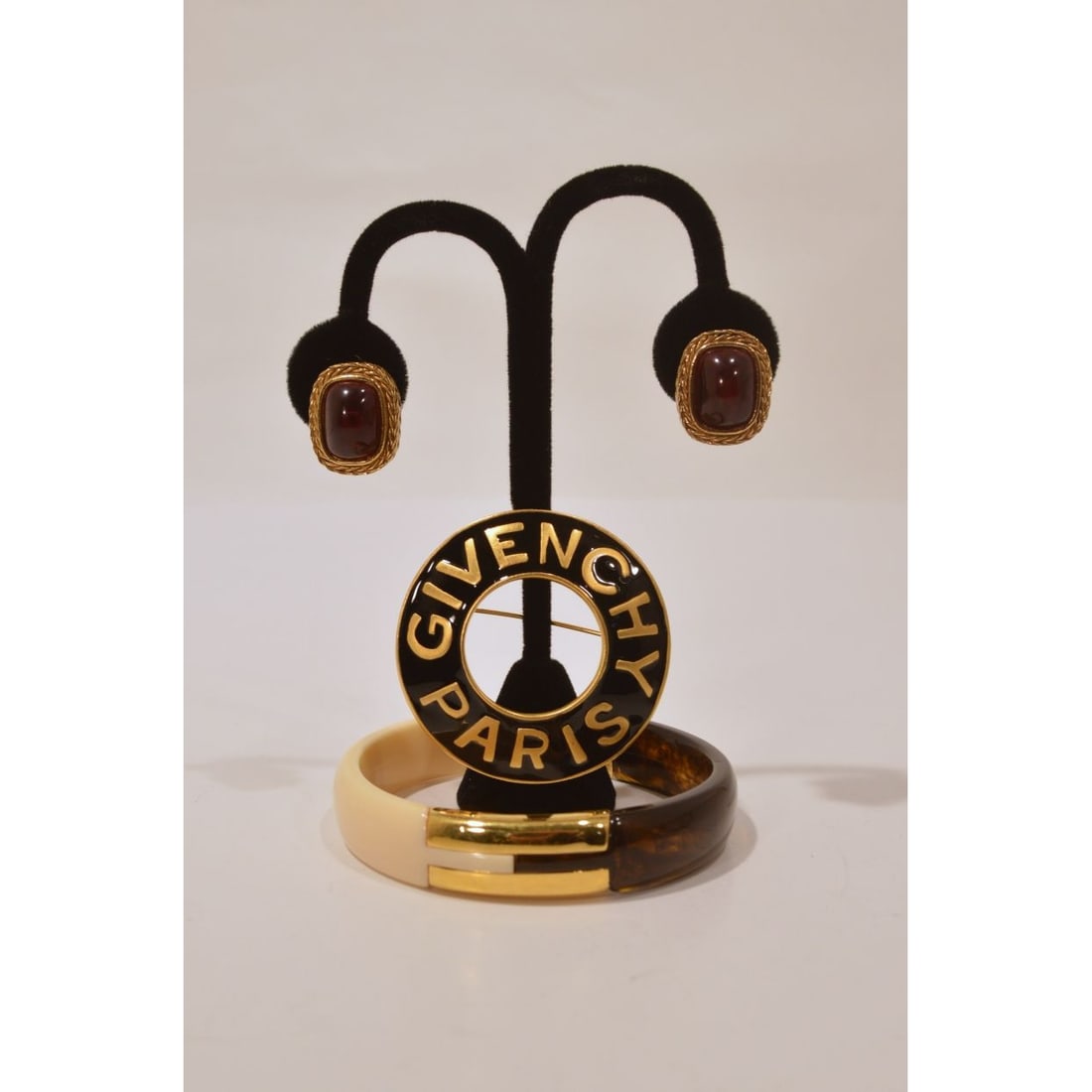 Givenchy Paris Pendant and Bangle: A Givenchy Paris Pendant and Bangle, Marked Givenchy. Together with a pair of clip on earrings. Bracelet diameter: 3 in.