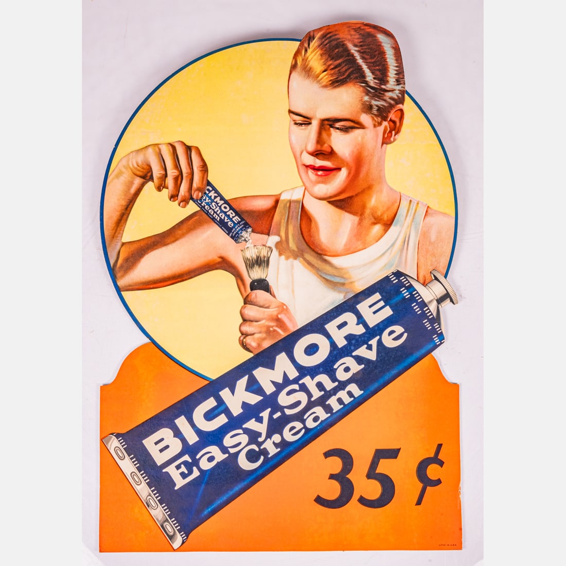 Bickmore Easy-Shave Cream Sign: Bickmore Easy-Shave Cream Sign, Mid 20th Century, A single-sided cardboard lithograph advertisement for Bickmore Easy-Shave Cream featuring a graphic of a man preparing to shave. Marked: Litho in USA.