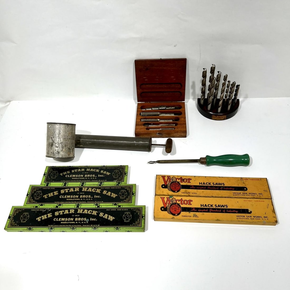 Vintage Drill Bits And Hack Saw Tins: A Collection of Vintage Drill Bits And Hack Saw Tins, Including a grease gun and rotary tool, Hack saw tins by Clemson Bros., Inc. and Victor Saw Works Inc. Drill bits housed in wooden storage base an