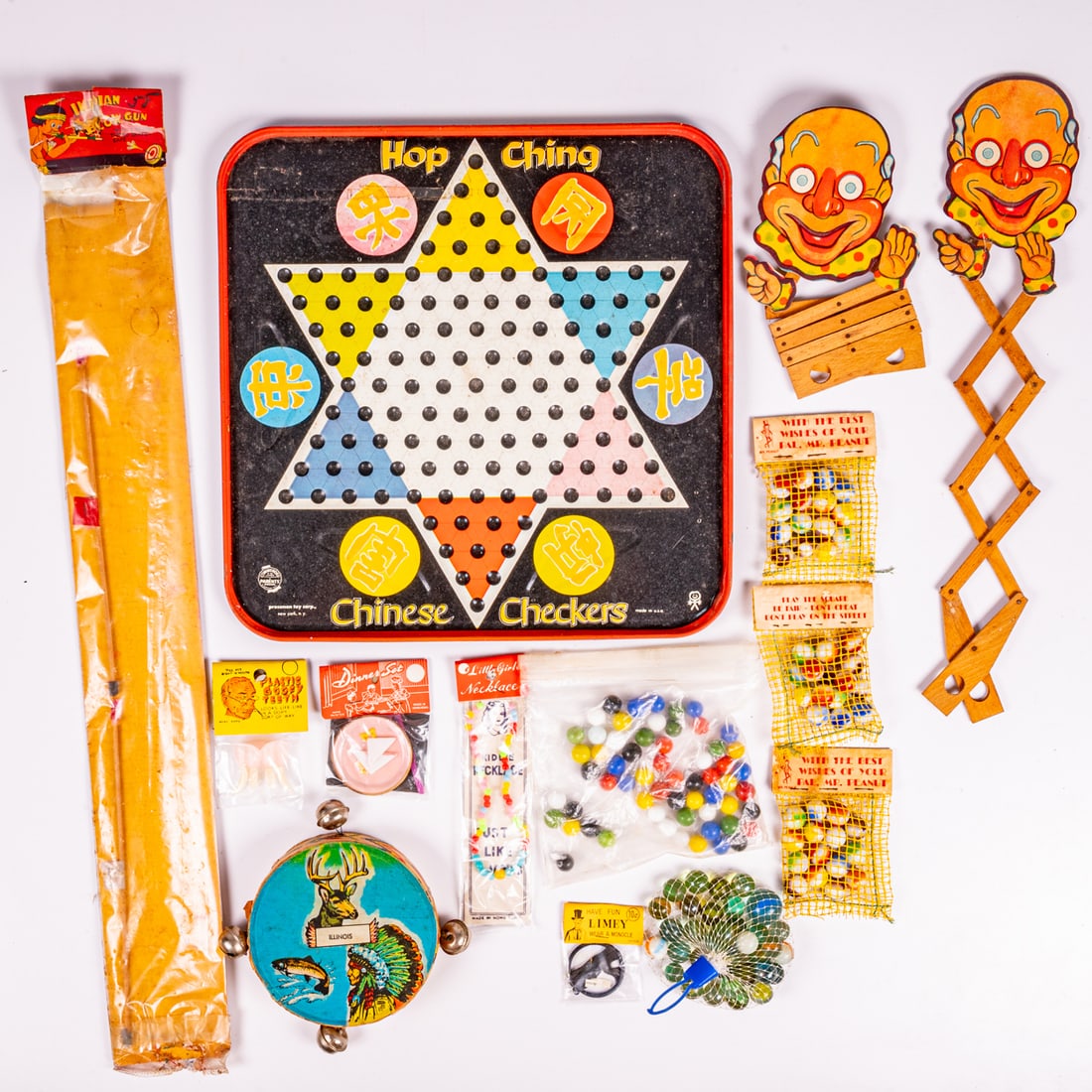 Vintage Games And Packaged Toys: A Collection Of Vintage Games And Packaged Toys, Mid 20th Century, One Chinese Checker Board and plastic bag of vintage glass marbles. Three new old stock net and paper packages of glass marbles, With