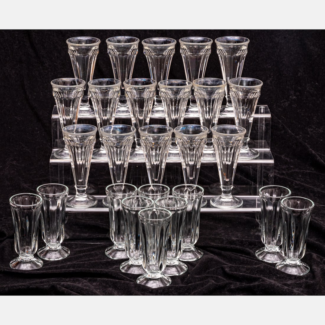 Twenty Six Ice Cream Sundae Glasses: A Set of Twenty Six Glass Ice Cream Sundae Glasses of Two Different Styles, Mid Century, One set of sixteen and another set of ten. Tallest dimension: H: 7 in. From a private NE Ohio single-owner coll
