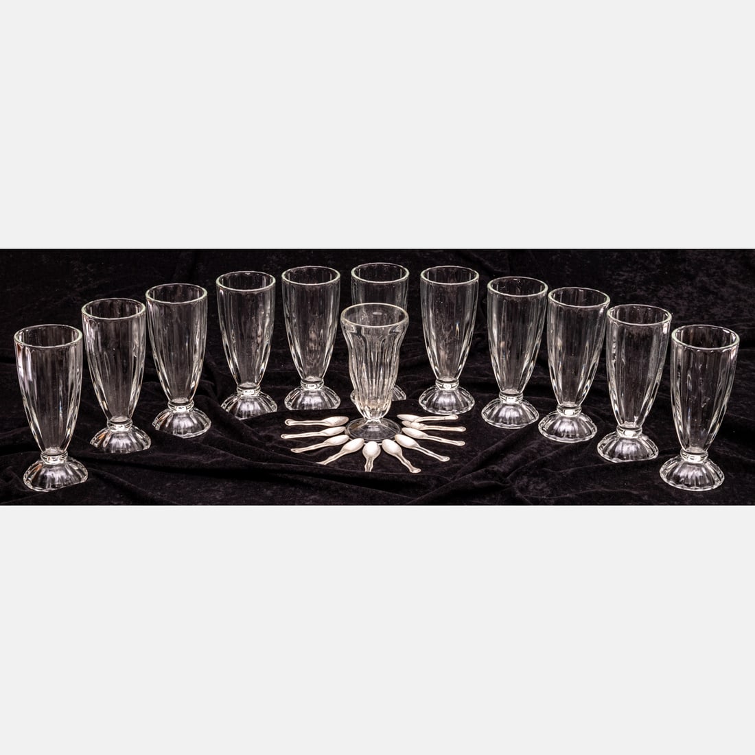 Twelve Ice Cream Sundae Glasses: A Set of Twelve Glass Ice Cream Sundae Glasses with Ten Metal Tasting Spoons, Mid Century. Tallest dimension: H: 7 1/2 in. From a private NE Ohio single-owner collection. Proceeds to benefit the Summi